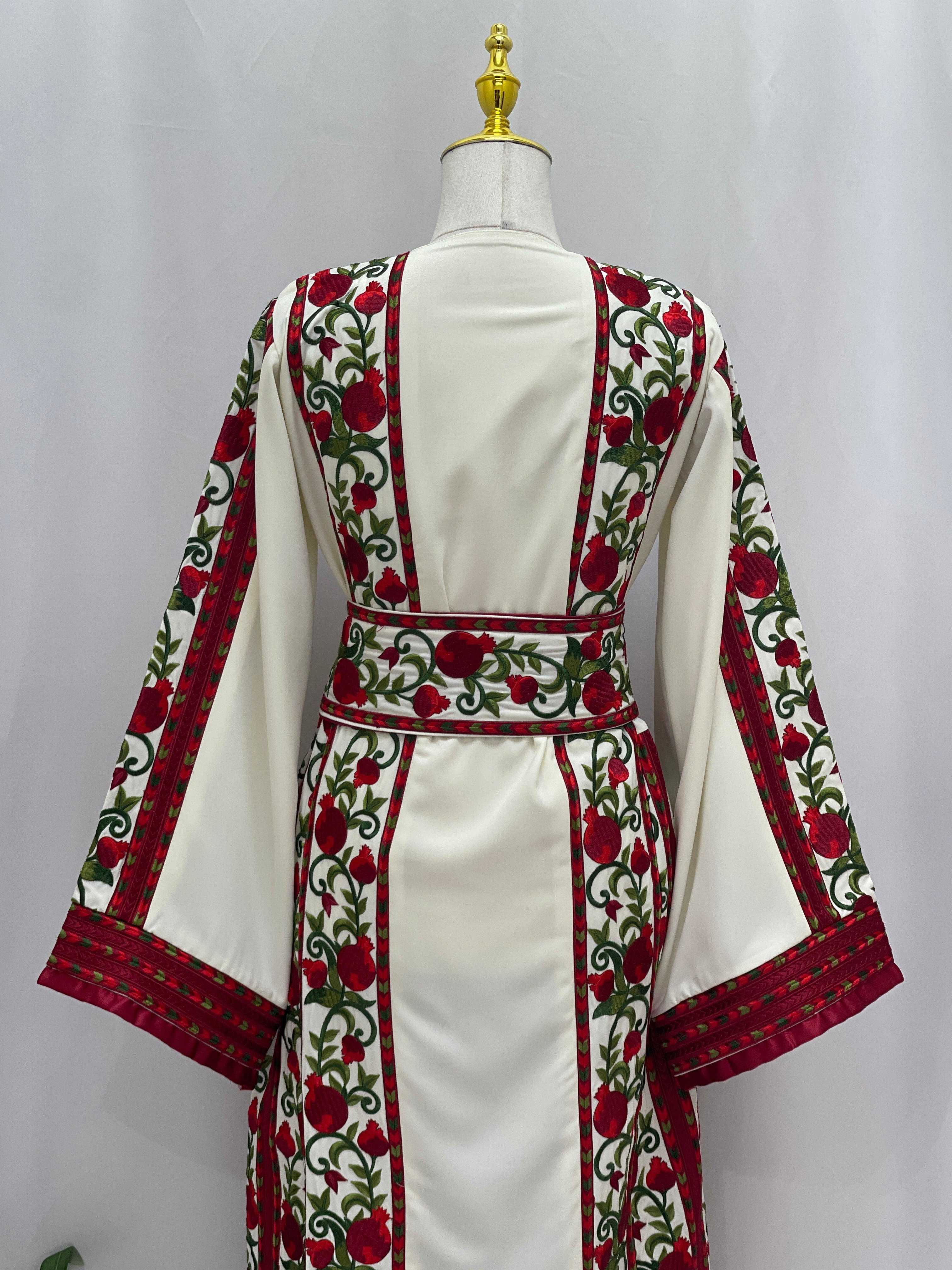 Al Romana Pomegranate Embroidered Thoub in white with red and green floral embroidery by Palestinian Elegance