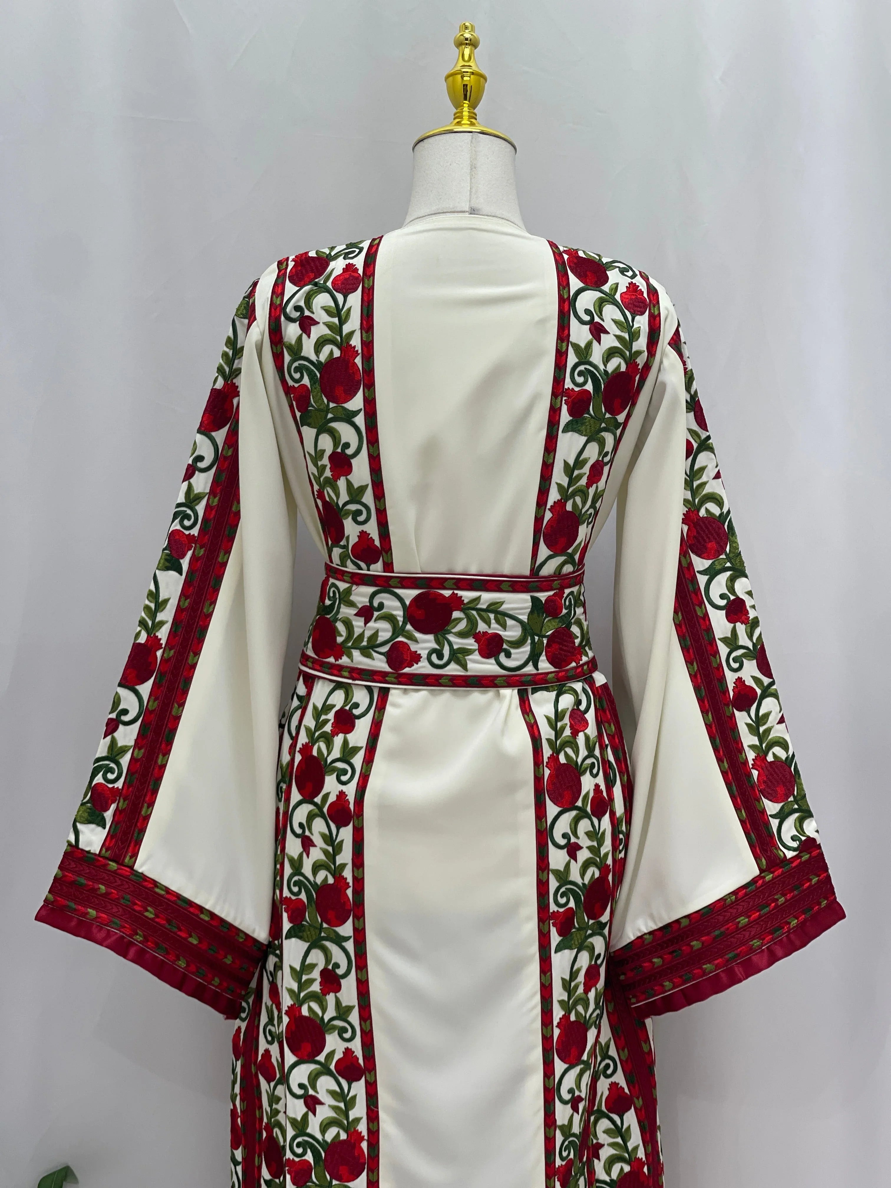 Al Romana Pomegranate Embroidered Thoub in white with red and green floral embroidery by Palestinian Elegance