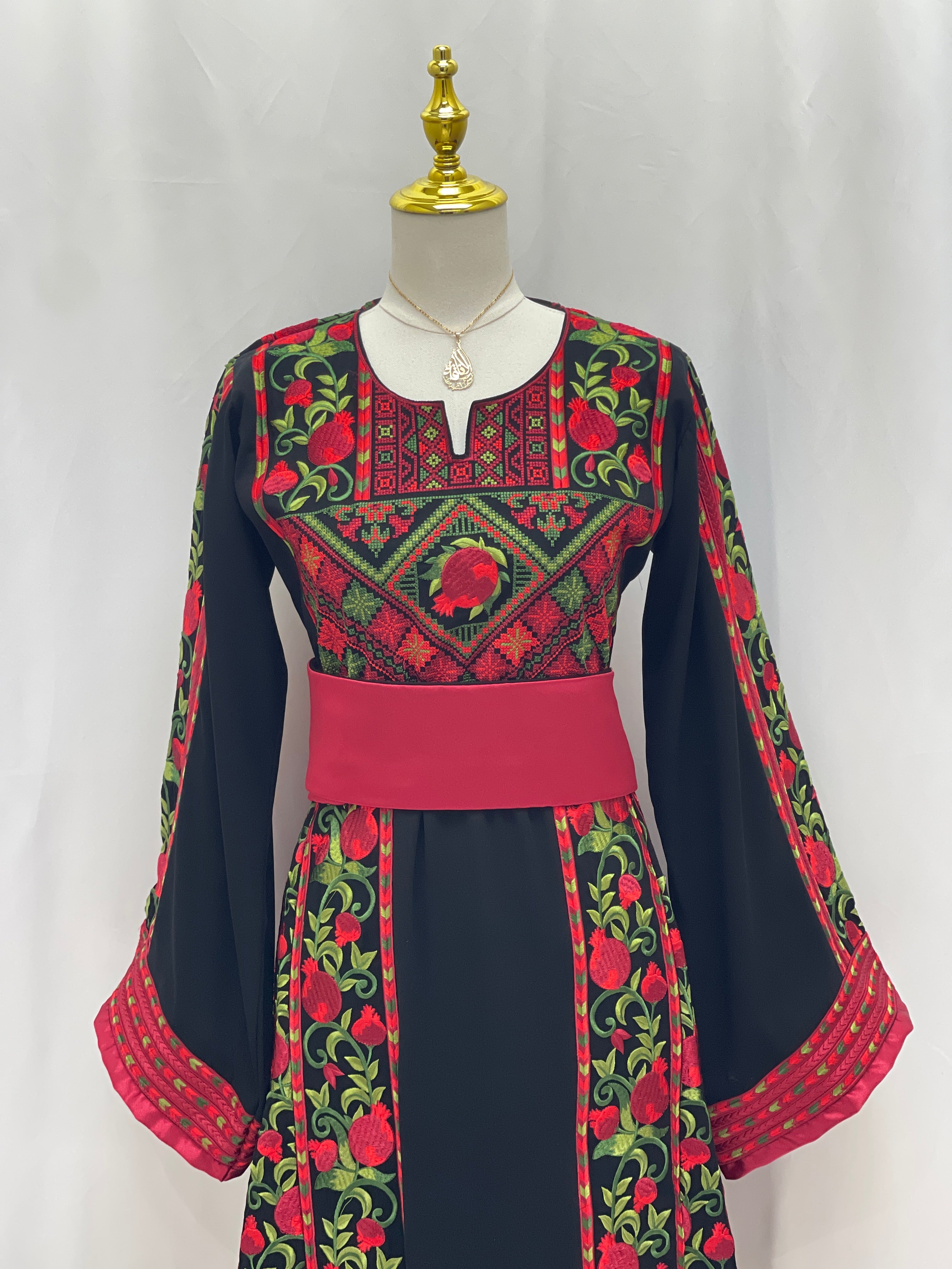 Al Romana Pomegranate Embroidered Thoub with vibrant red and green floral patterns on black fabric