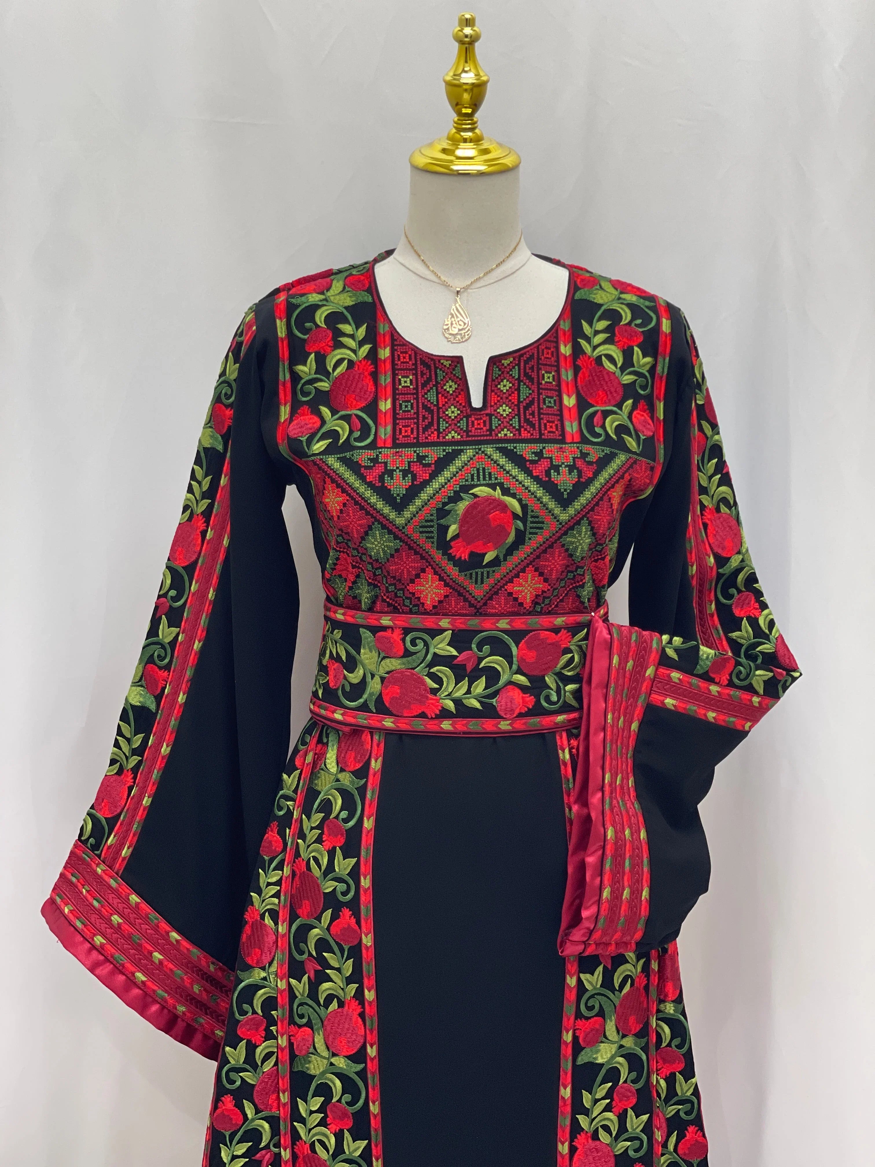 Al Romana Pomegranate Embroidered Thoub black fabric with red and green intricate embroidery by Palestinian Elegance