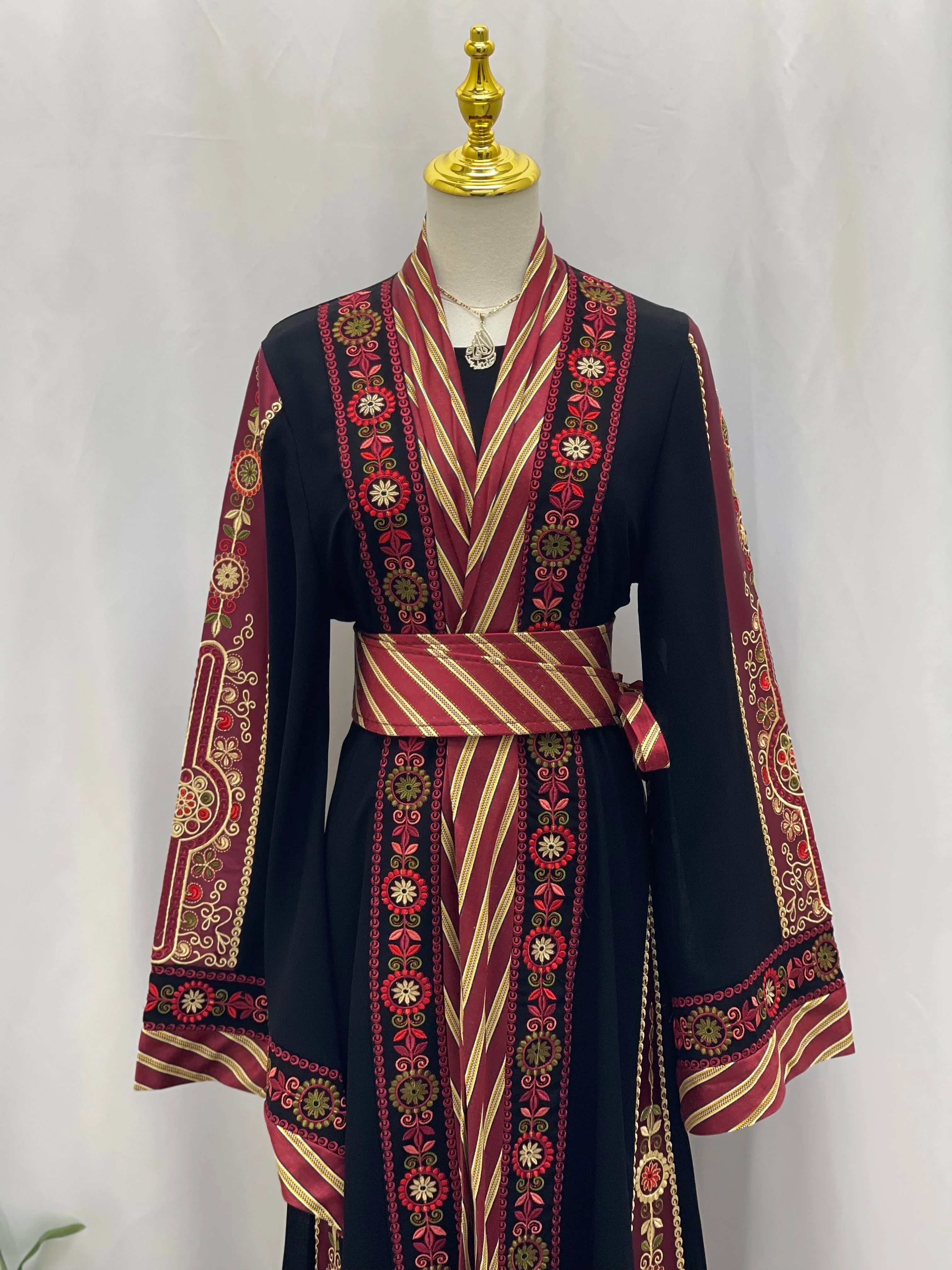 Palestinian Elegance embroidered Kashmir abaya with intricate red and gold floral designs on black fabric