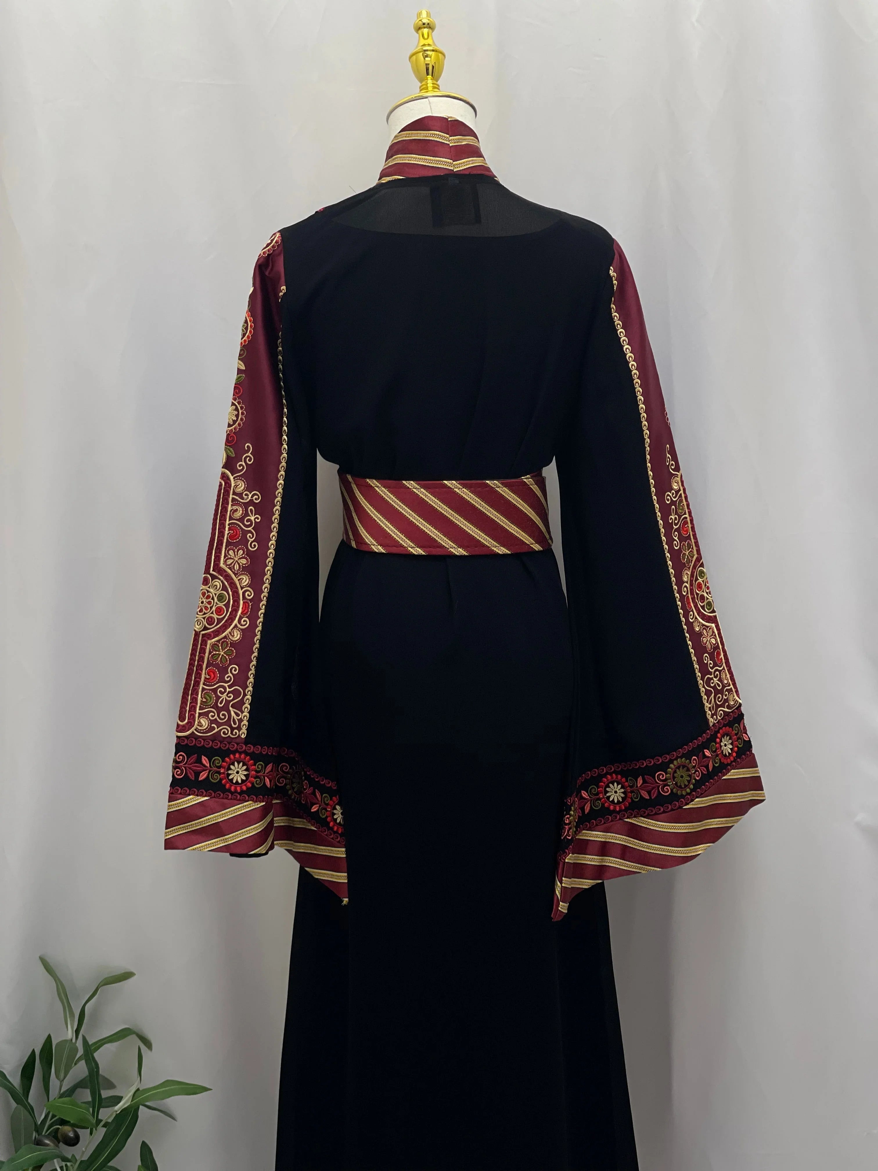 Back view of embroidered Kashmir abaya with black fabric and intricate red and gold sleeve embroidery