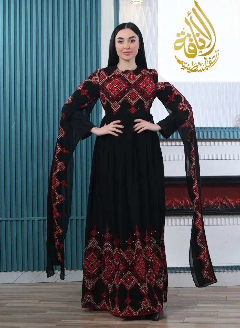 Black modern embroidered Palestinian dress with red geometric patterns and long flowing sleeves