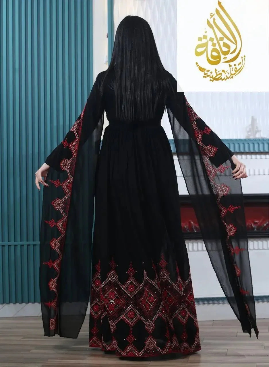 Black modern embroidered Palestinian dress with red geometric embroidery and flowing sheer sleeves