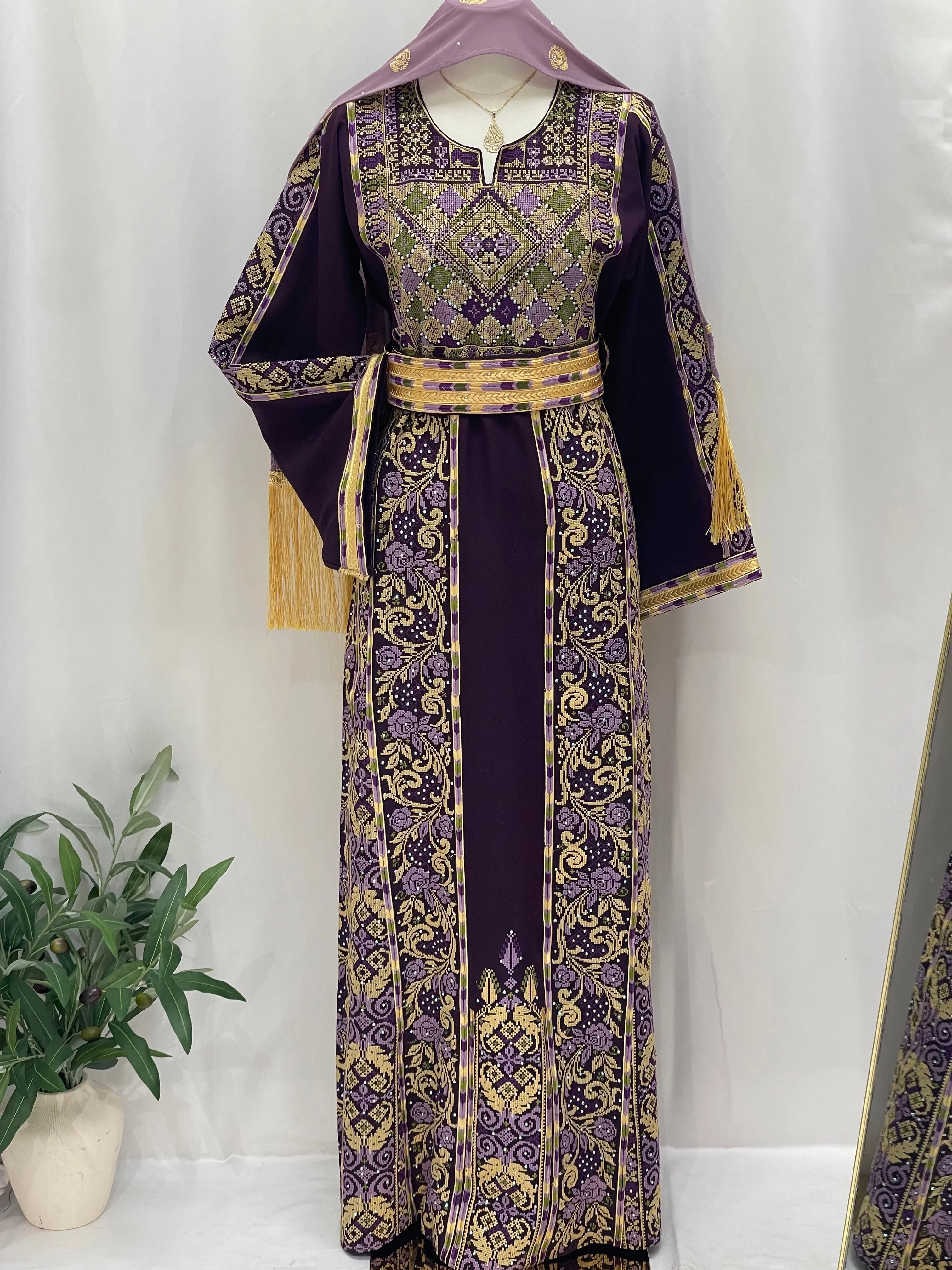 Arjwan Embroidered Thoub in rich purple with intricate gold patterns and elegant fringes