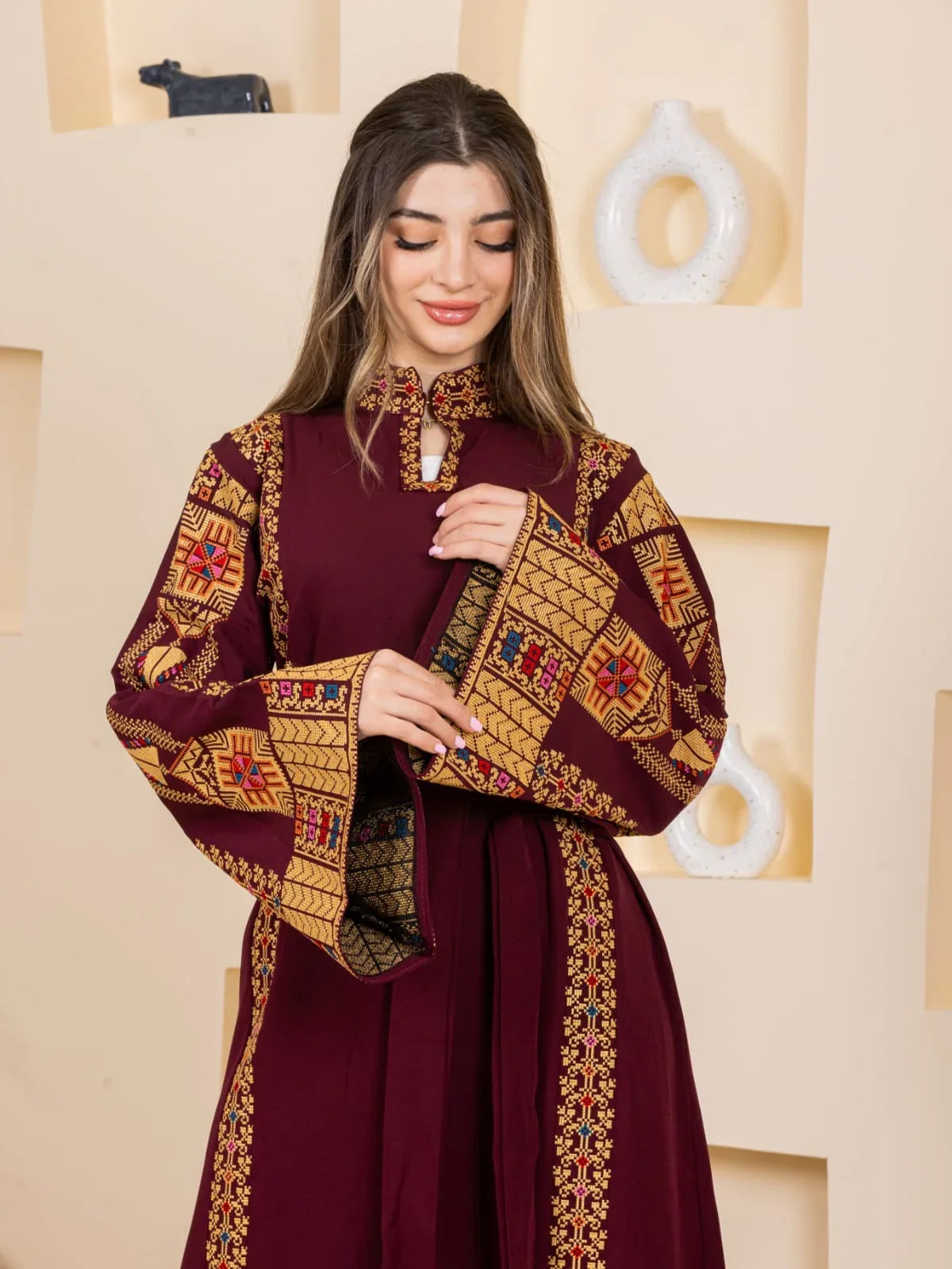 Asala Embroidered Thoub from Palestinian Elegance burgundy embroidered thobe with gold geometric Palestinian motifs