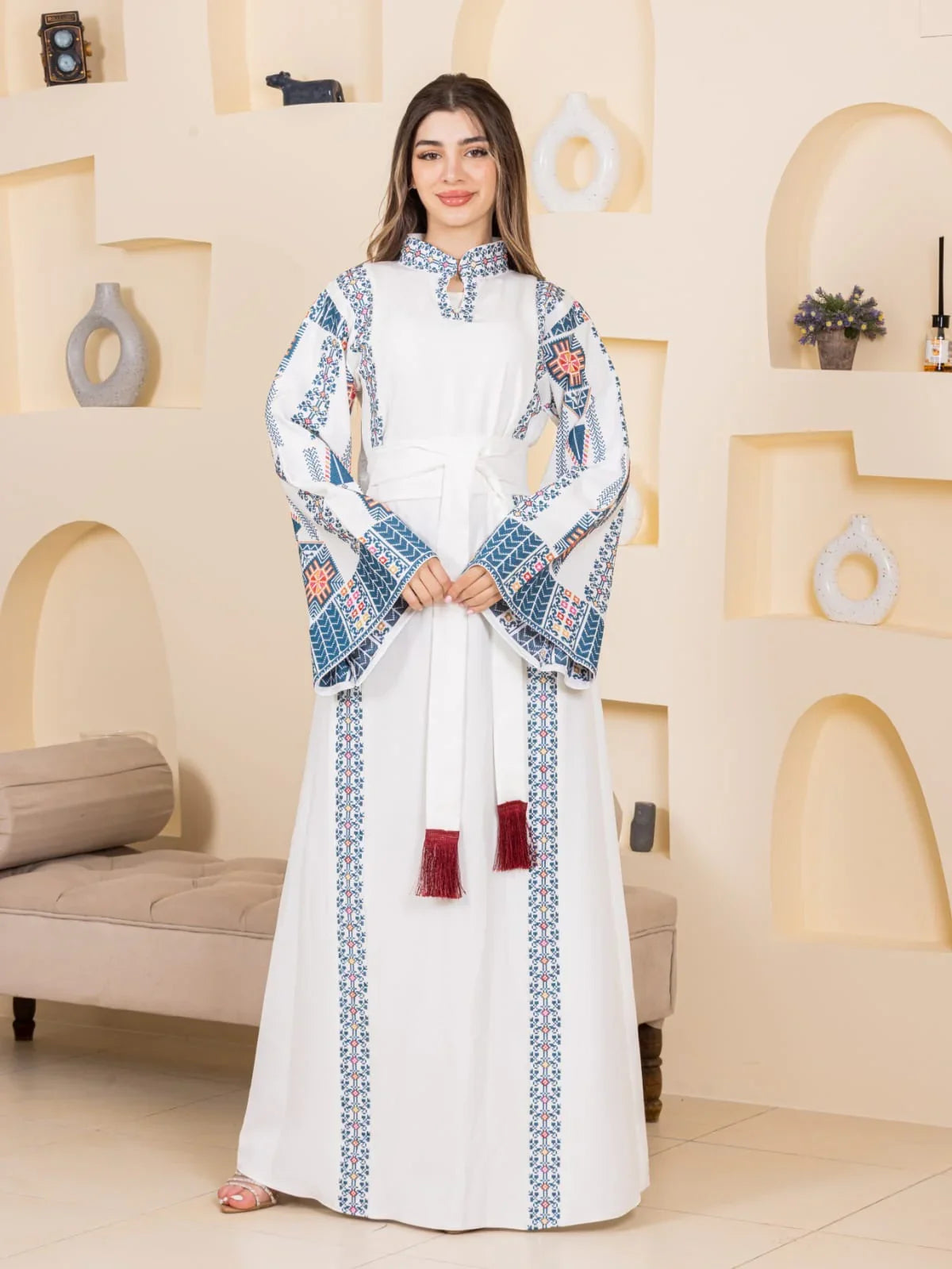 Asala Embroidered Thoub white Palestinian thobe with blue geometric embroidery long bell sleeves tassel belt