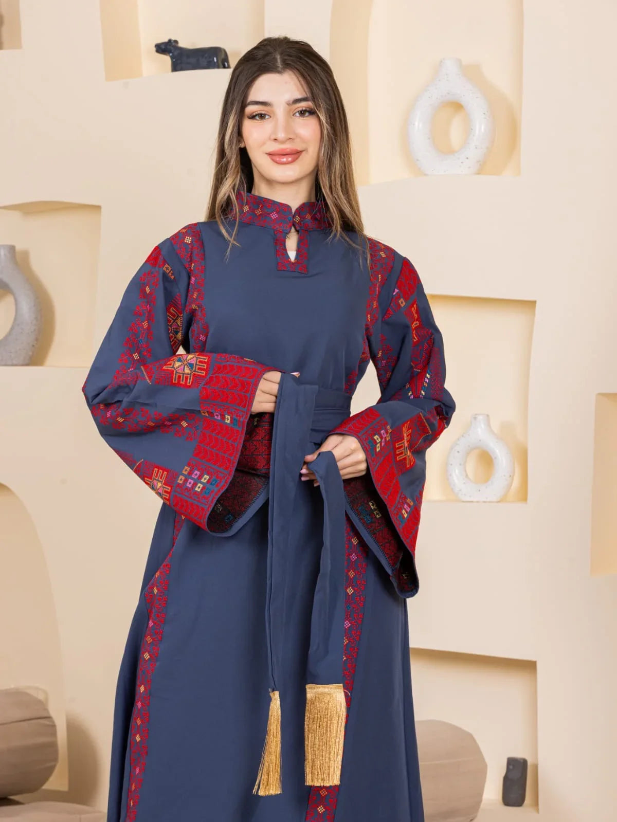 Asala Embroidered Thoub by Palestinian Elegance navy blue embroidered thobe with red geometric embroidery and tassel belt