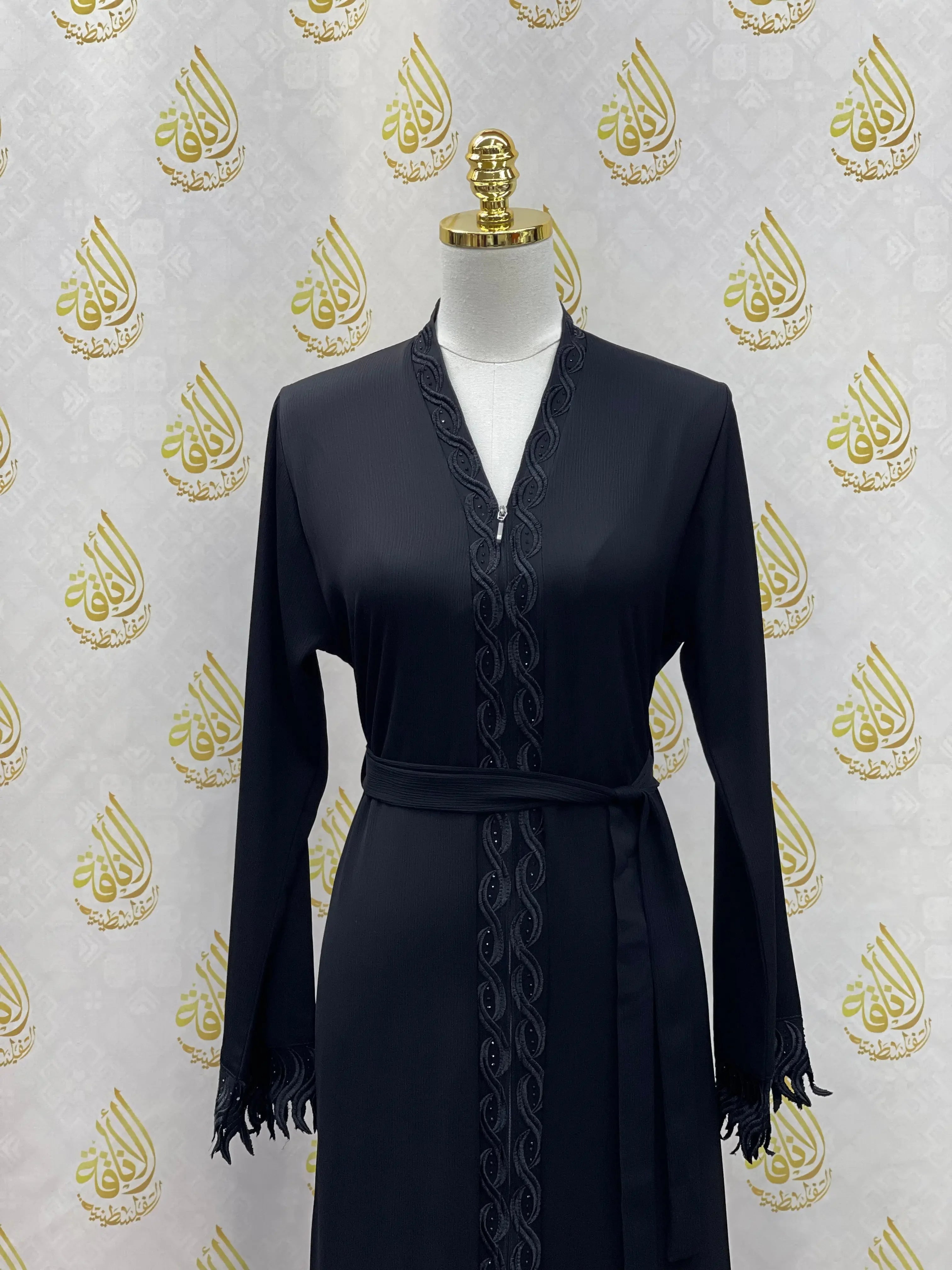 Palestinian Elegance elegant embroidered abaya in black with detailed embroidery and belt on mannequin