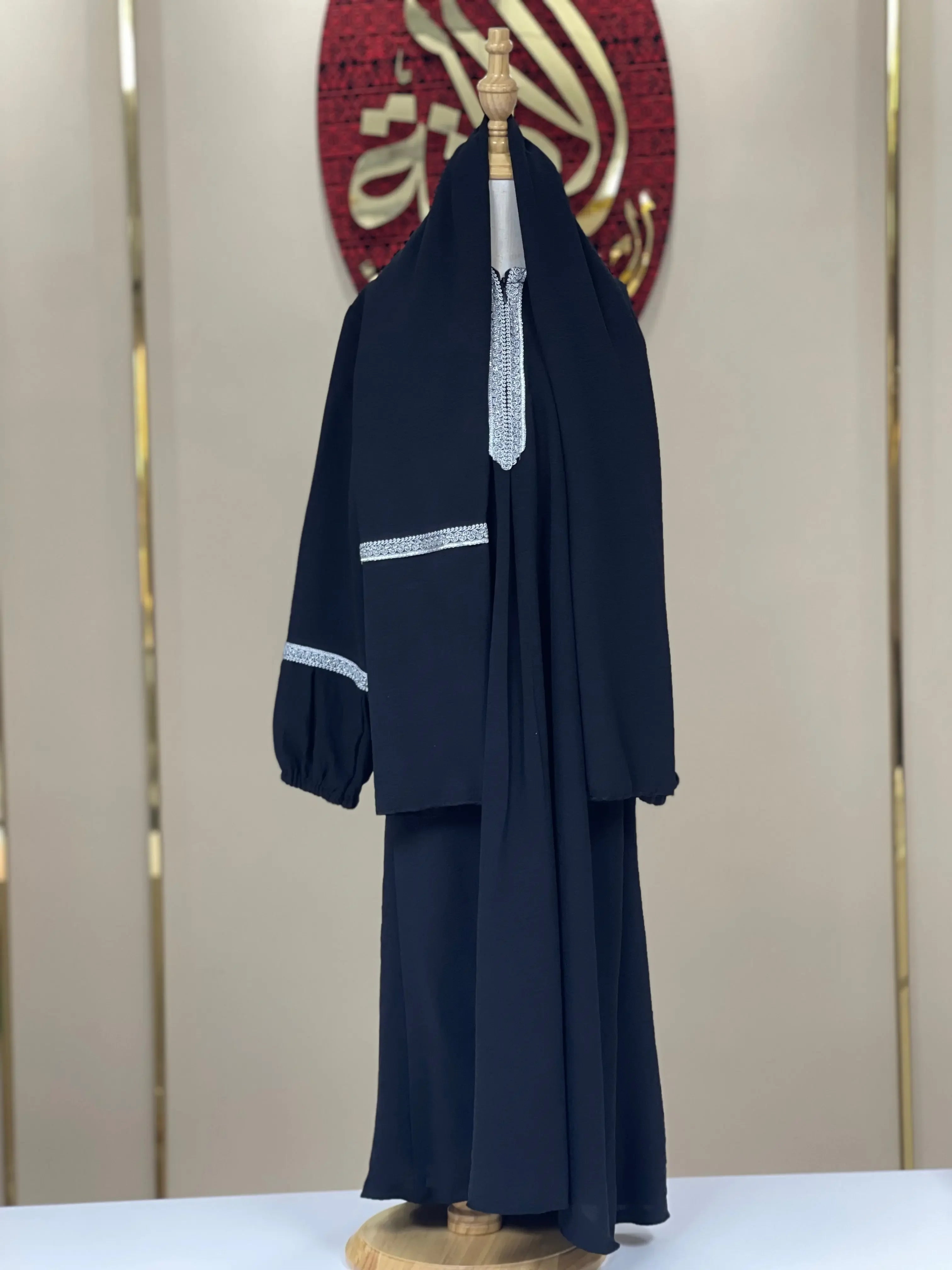 Palestinian Elegance girls embroidered abaya in black with white detailed embroidery on sleeve and front