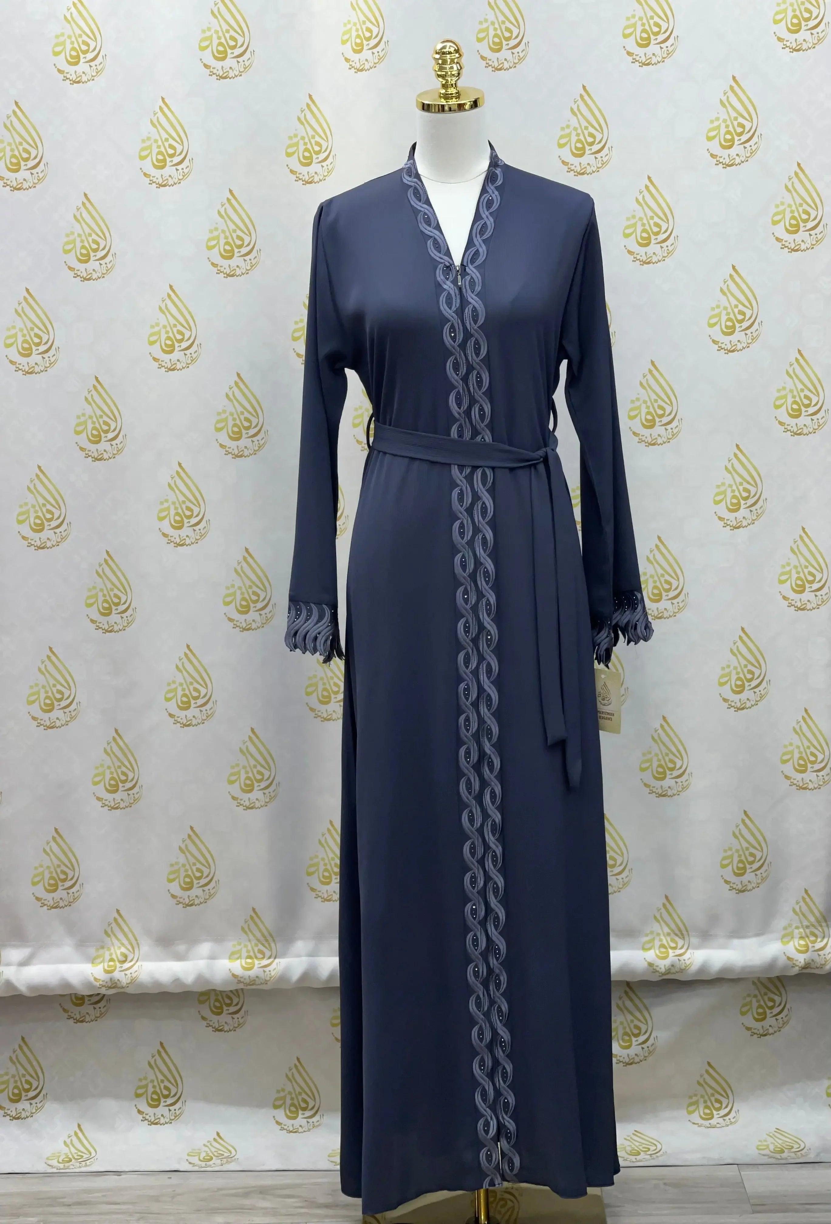 Palestinian Elegance elegant embroidered abaya in navy blue with detailed trim and waist belt