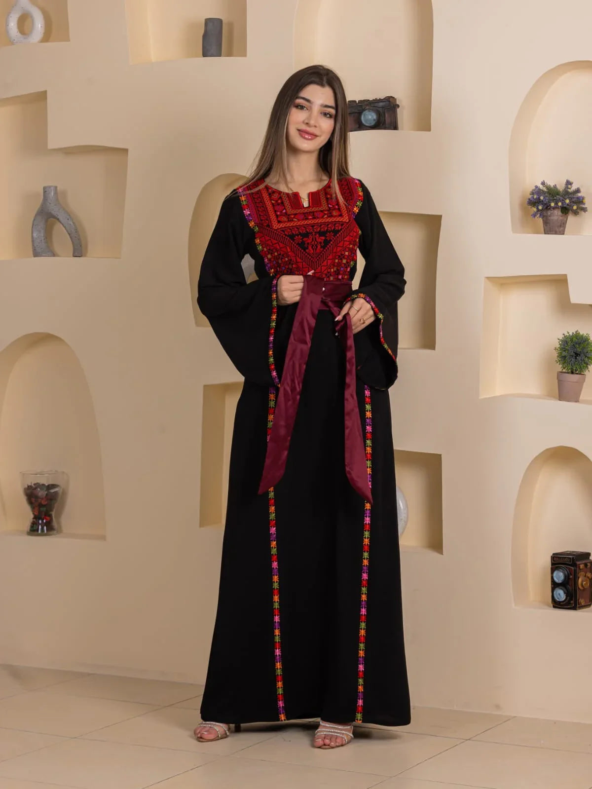 Blossom Embroidered Thobe by Palestinian Elegance black traditional thobe with red floral chest embroidery and sash