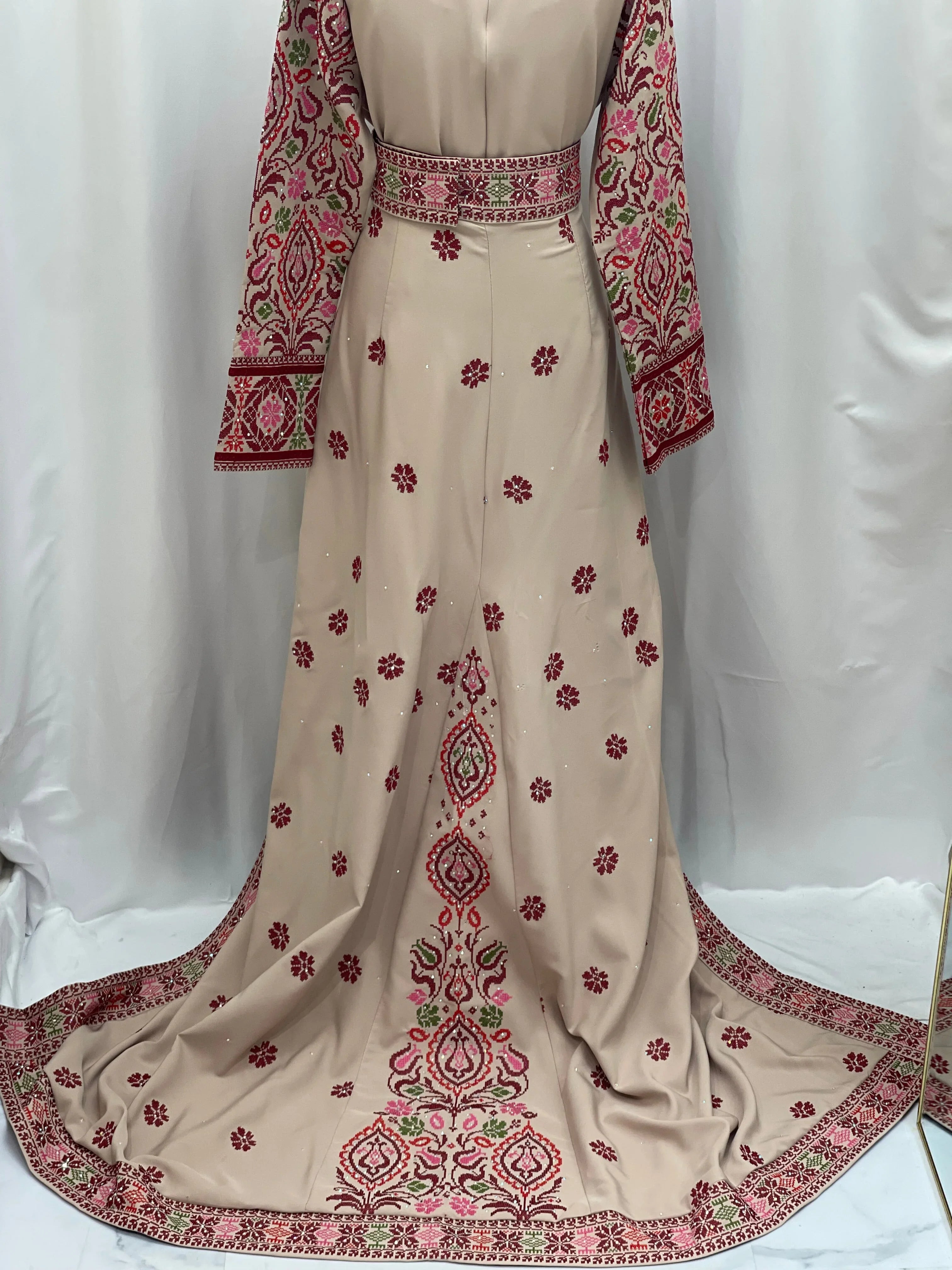 Bride of Roses Thobe featuring detailed embroidered floral patterns in red and green on a soft beige fabric