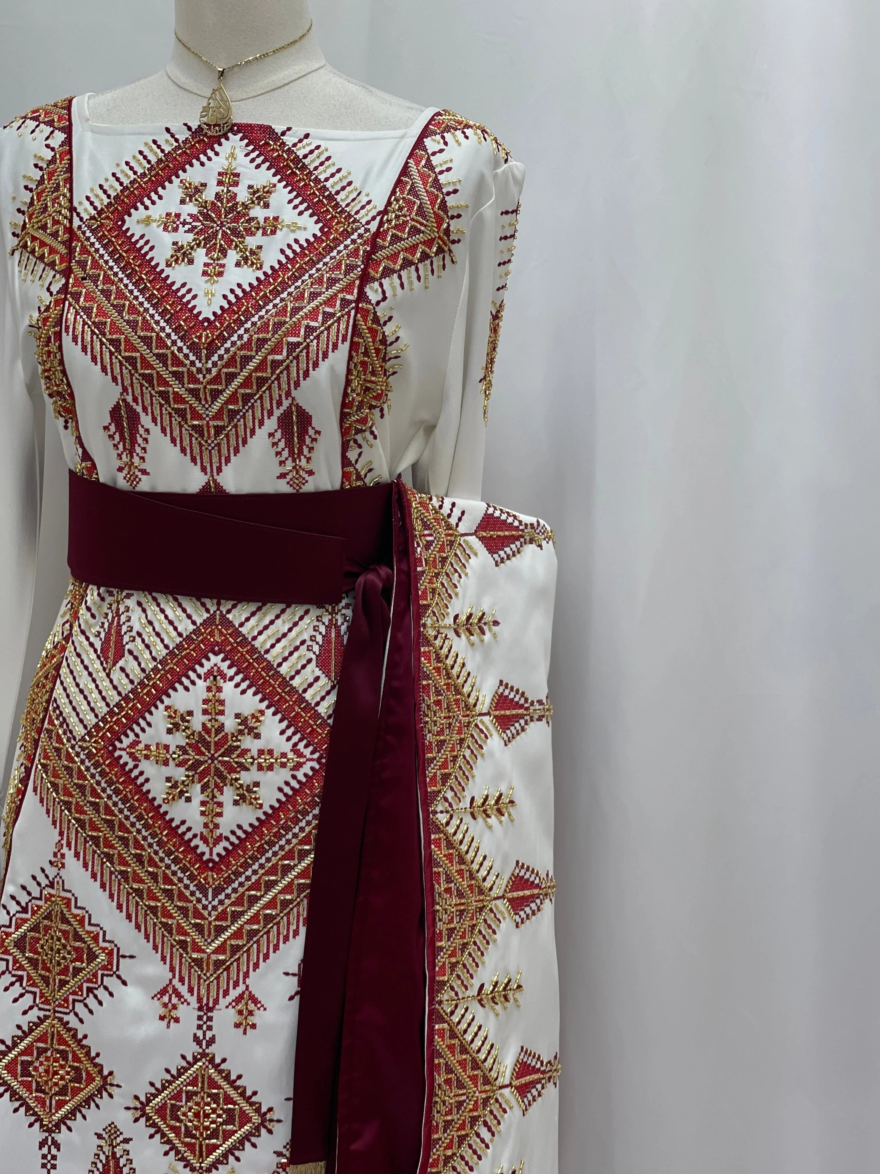 Orient Modren Embroidered Dress Palestinian Elegance white thobe with red and gold geometric embroidery and maroon sash