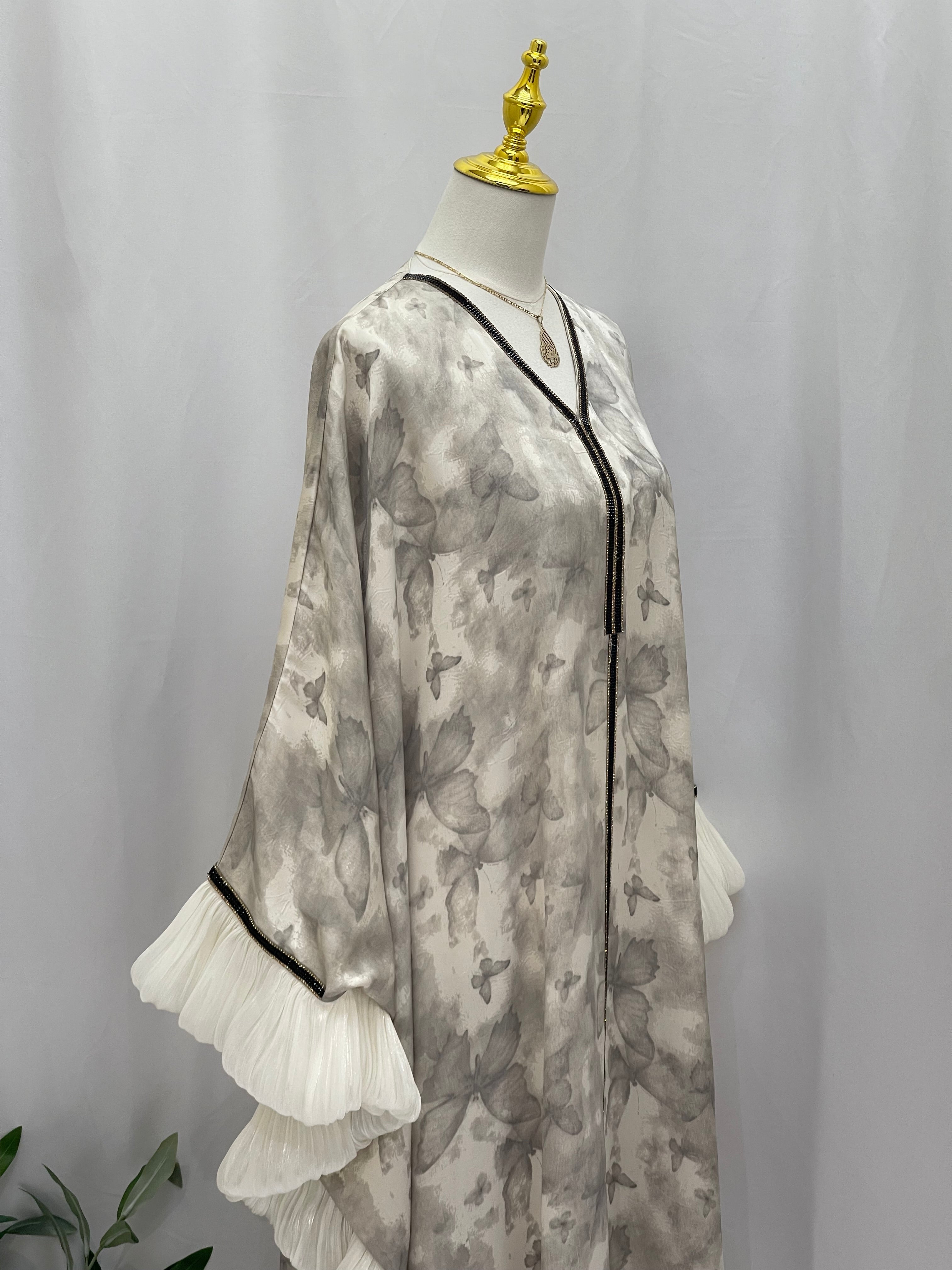 Palestinian Elegance butterfly abaya free size in gray with black trim and white ruffled sleeves
