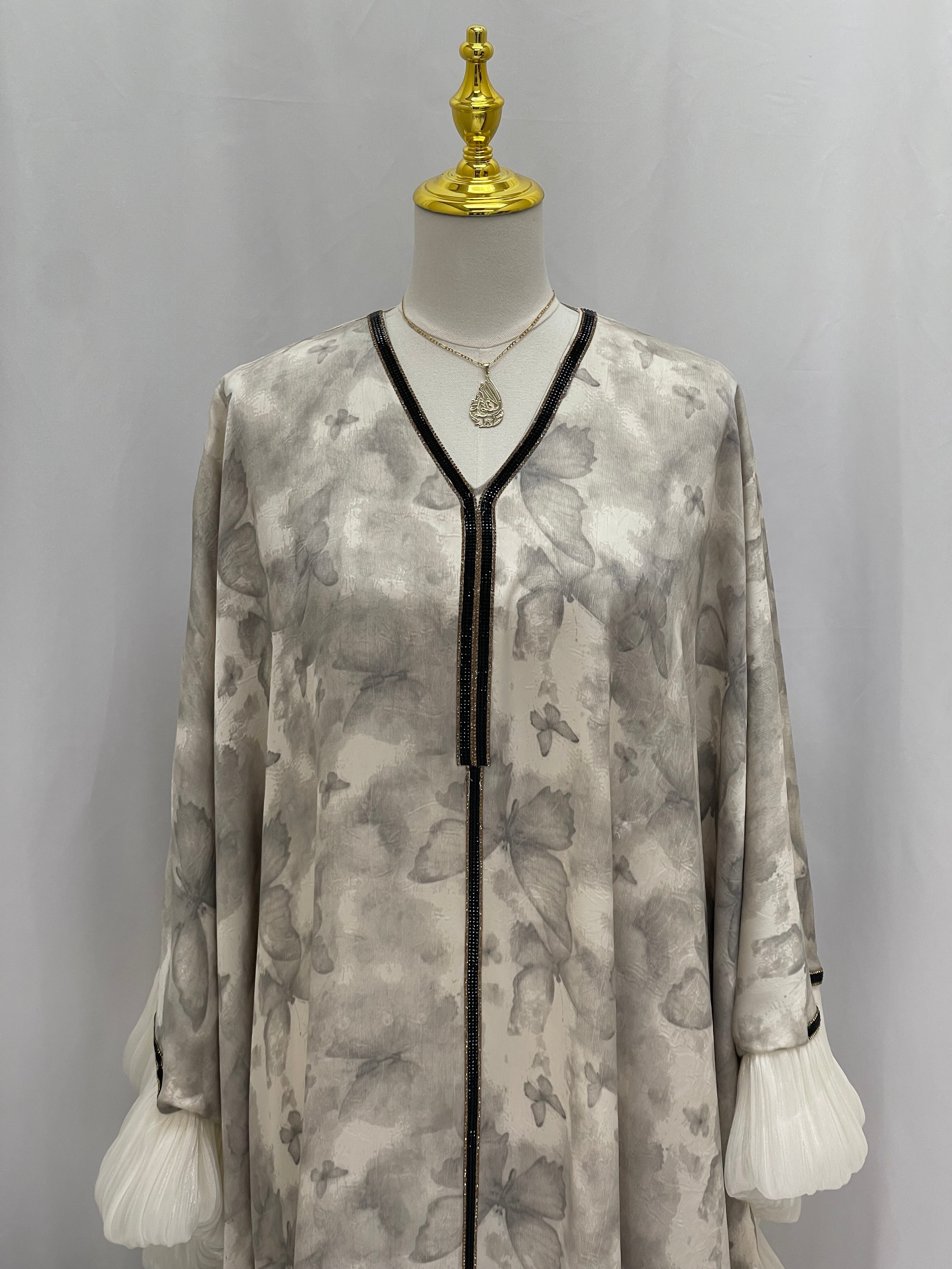 Palestinian Elegance butterfly abaya free size in soft beige with butterfly prints and black trim detailing