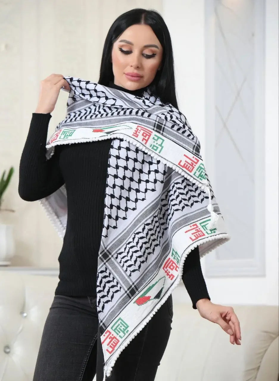 Woman wearing black outfit with embroidered Palestinian kuffiyeh draped over shoulders by Palestinian Elegance