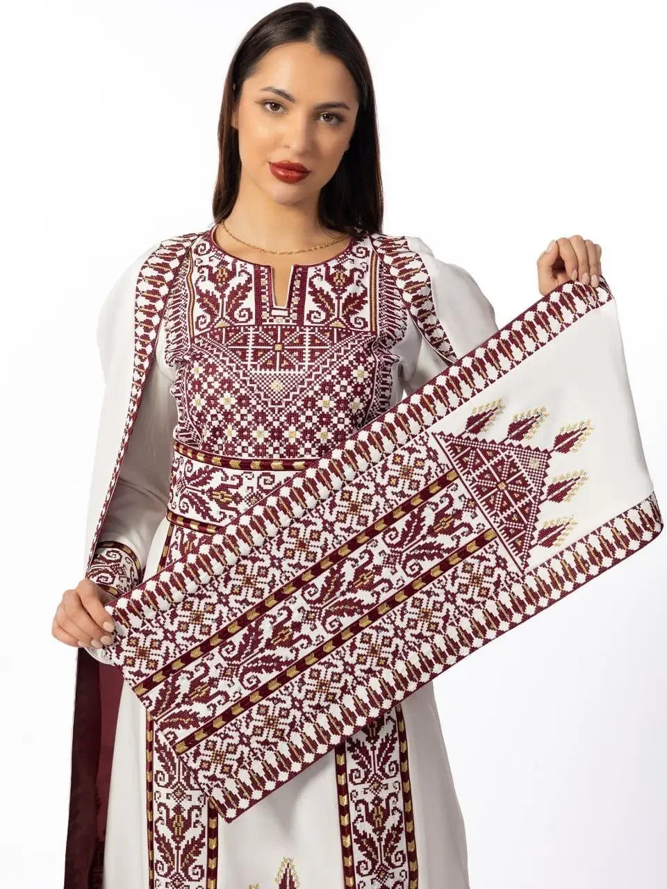 Woman wearing embroidered Palestinian thobe dress with intricate maroon and white embroidery by Palestinian Elegance