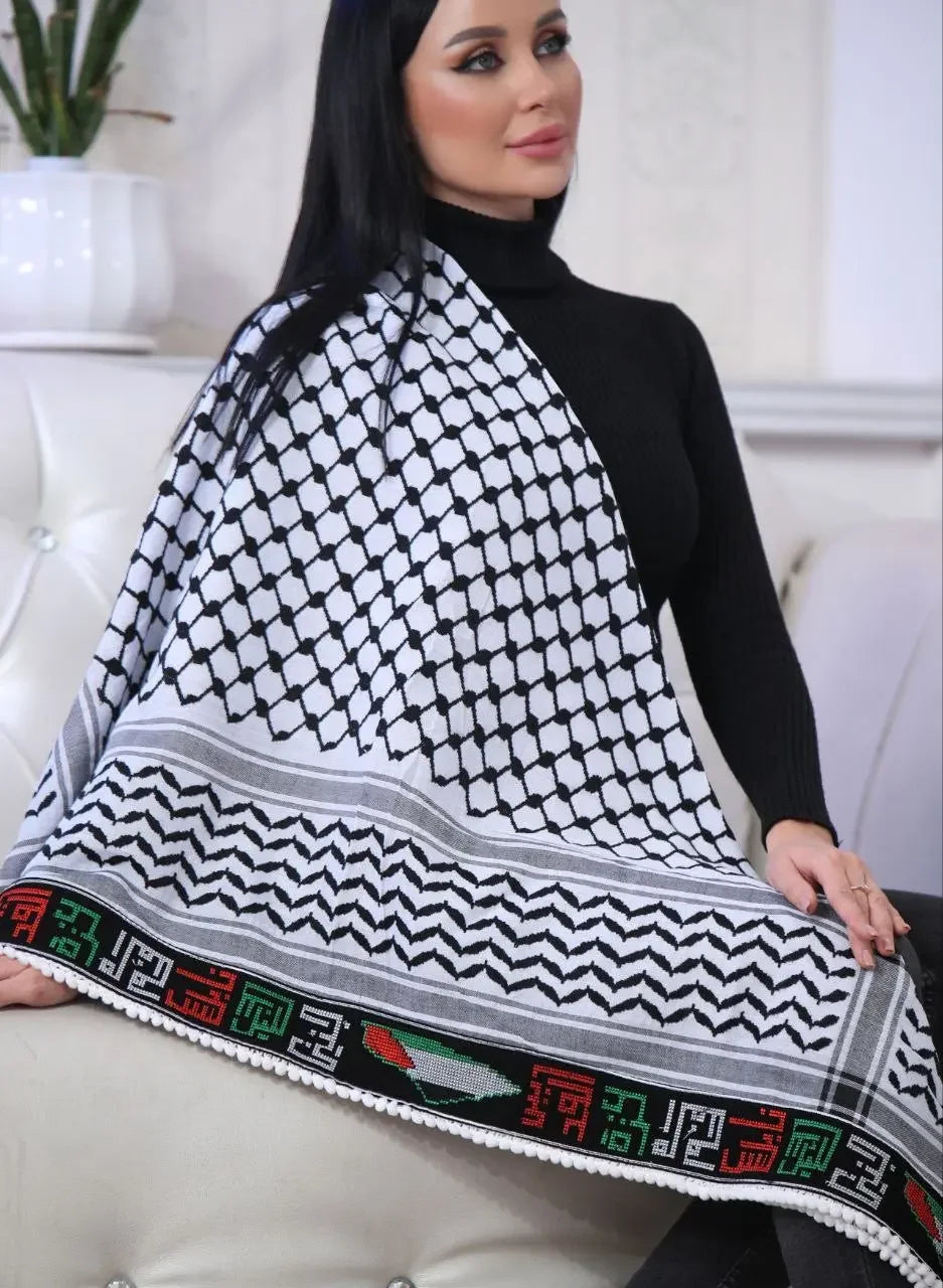 Woman wearing embroidered Palestinian kuffiyeh scarf with traditional black and white pattern and colorful border