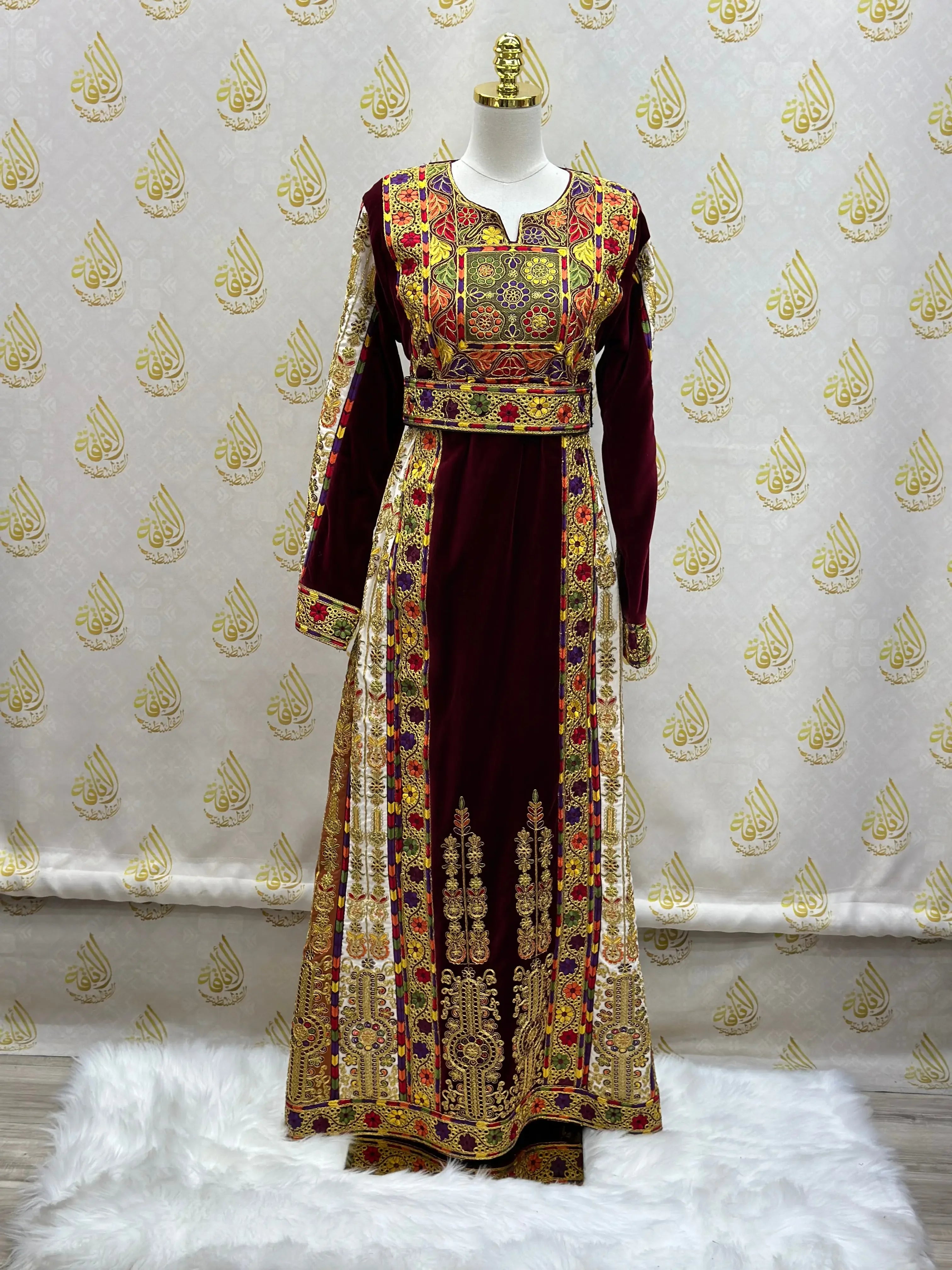 Velvet Palestinian dress with intricate embroidery by Palestinian Elegance on a mannequin