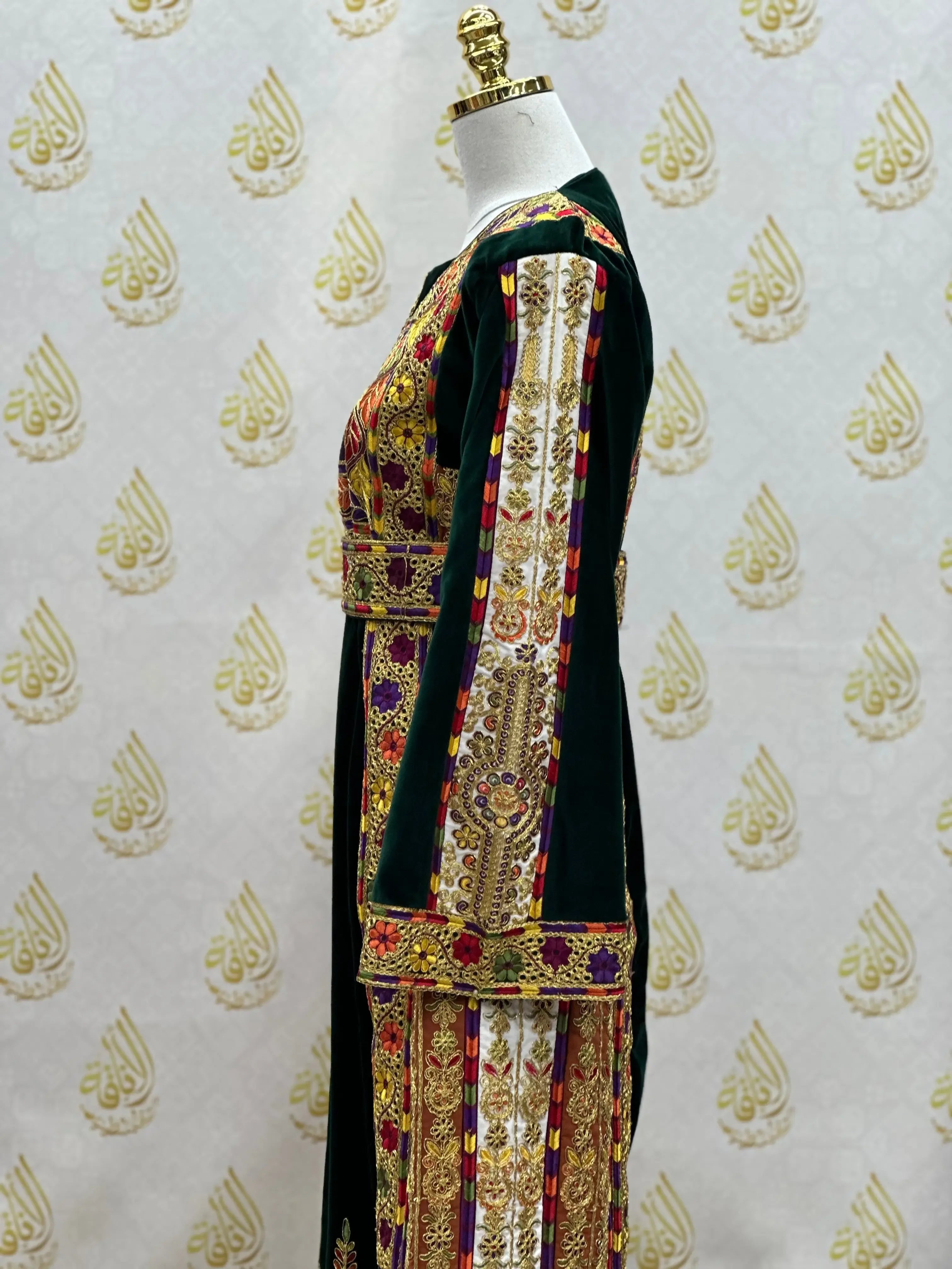 Velvet Palestinian dress with intricate traditional embroidery on a mannequin by Palestinian Elegance