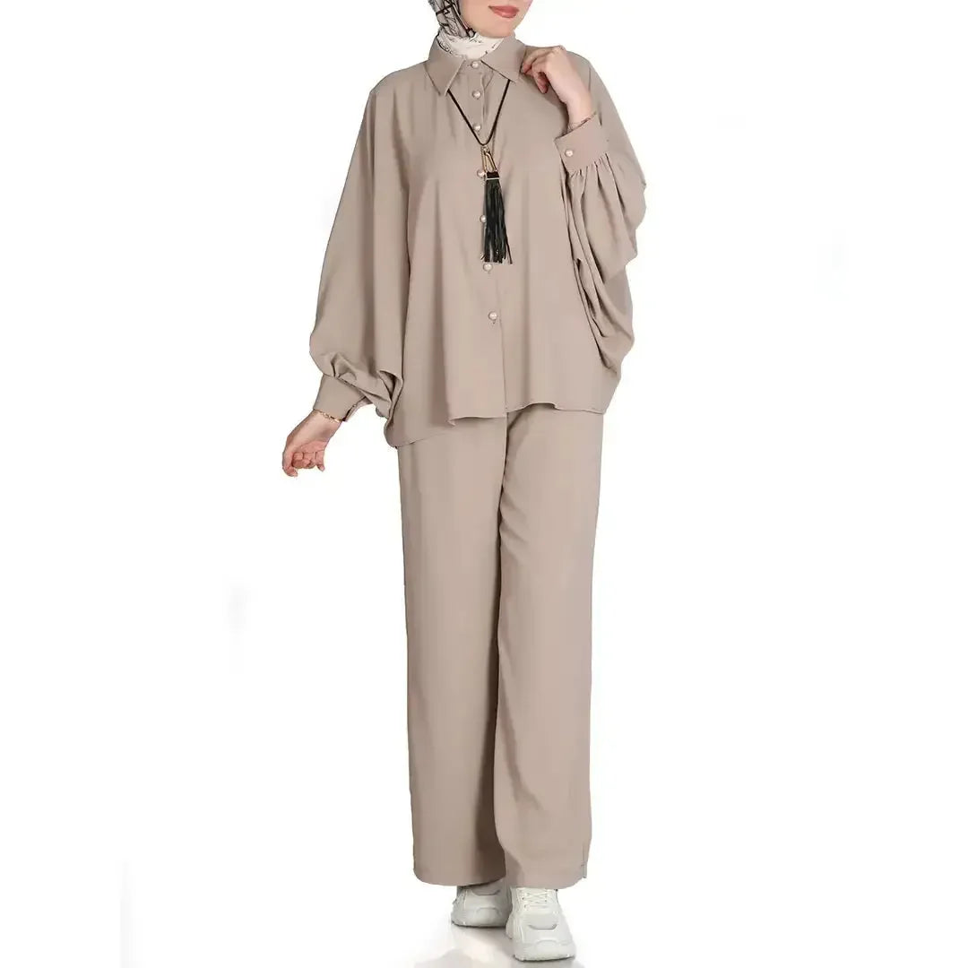 Palestinian Elegance casual chic summer outfit for women featuring loose beige top and pants with white sneakers