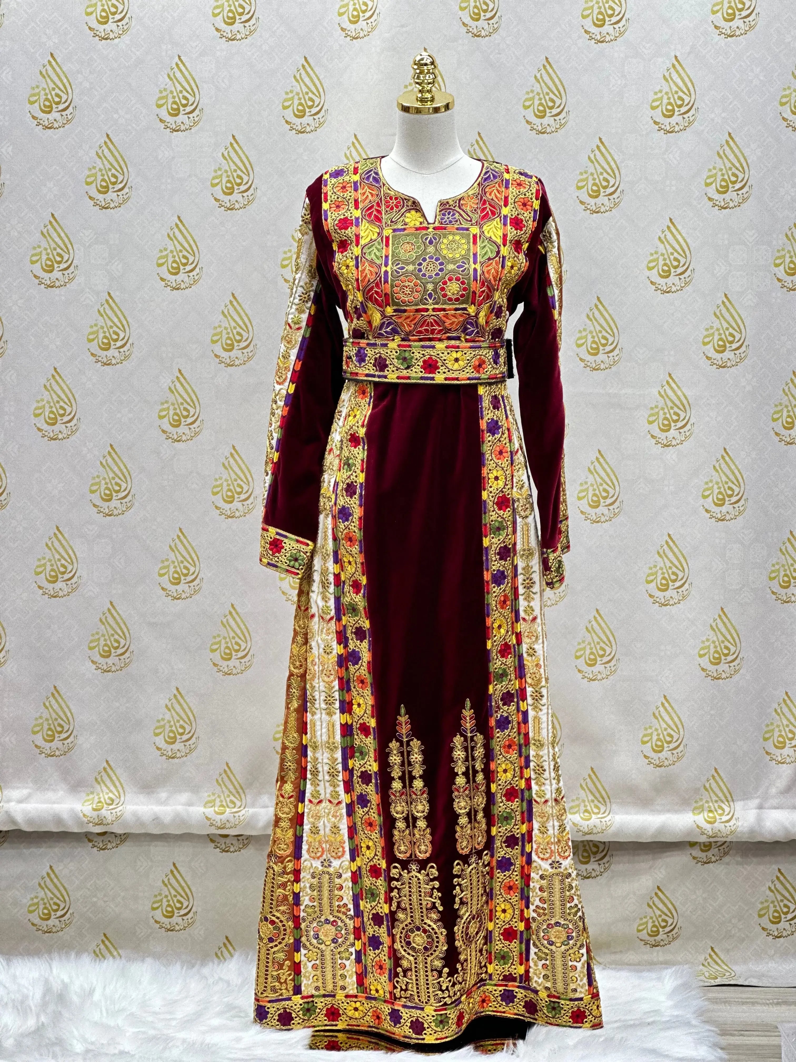 Velvet Palestinian dress with vibrant traditional embroidery by Palestinian Elegance on a mannequin