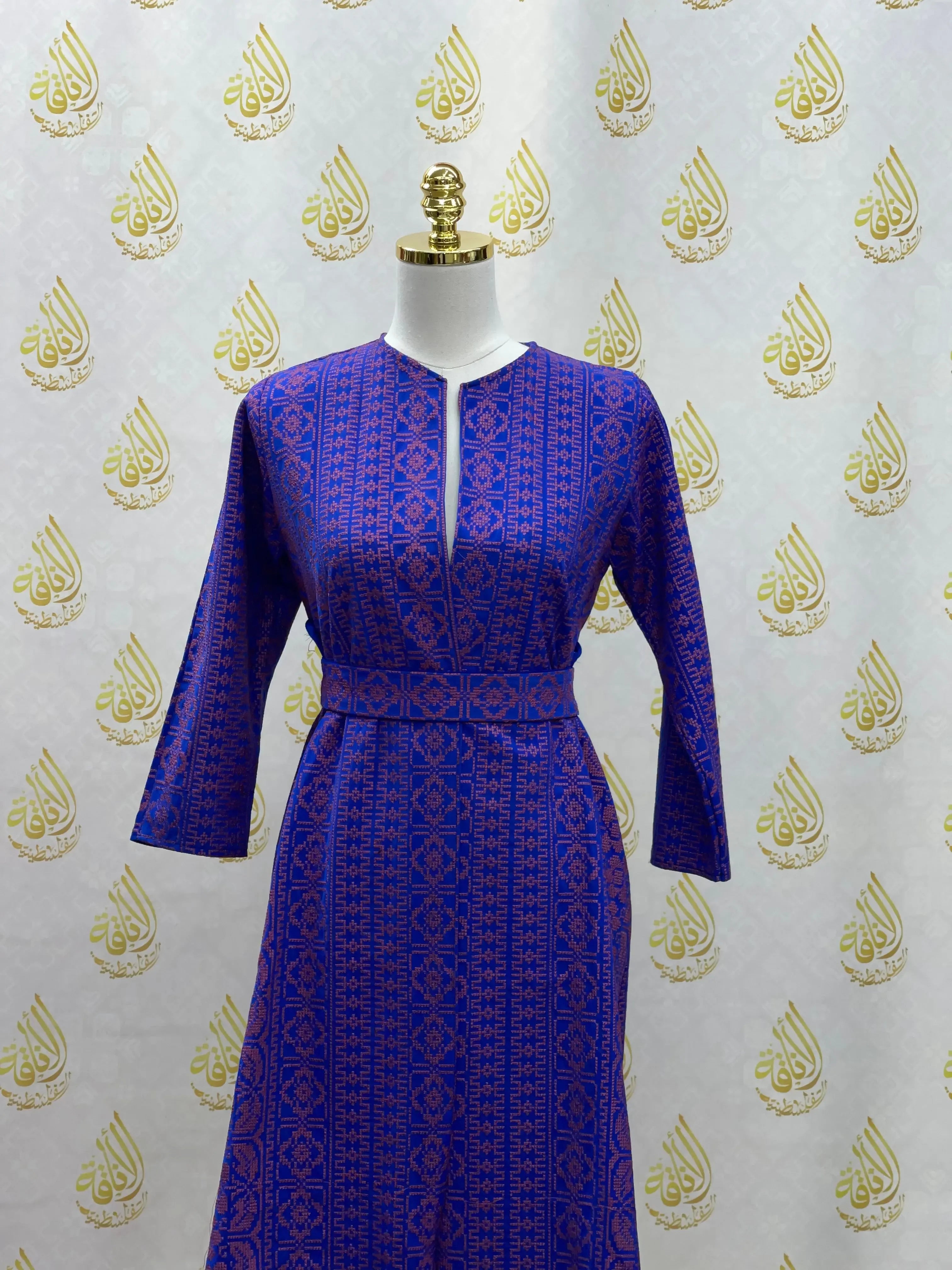 Blue embroidered cardigan for kids with traditional Palestinian Elegance patterns on a mannequin