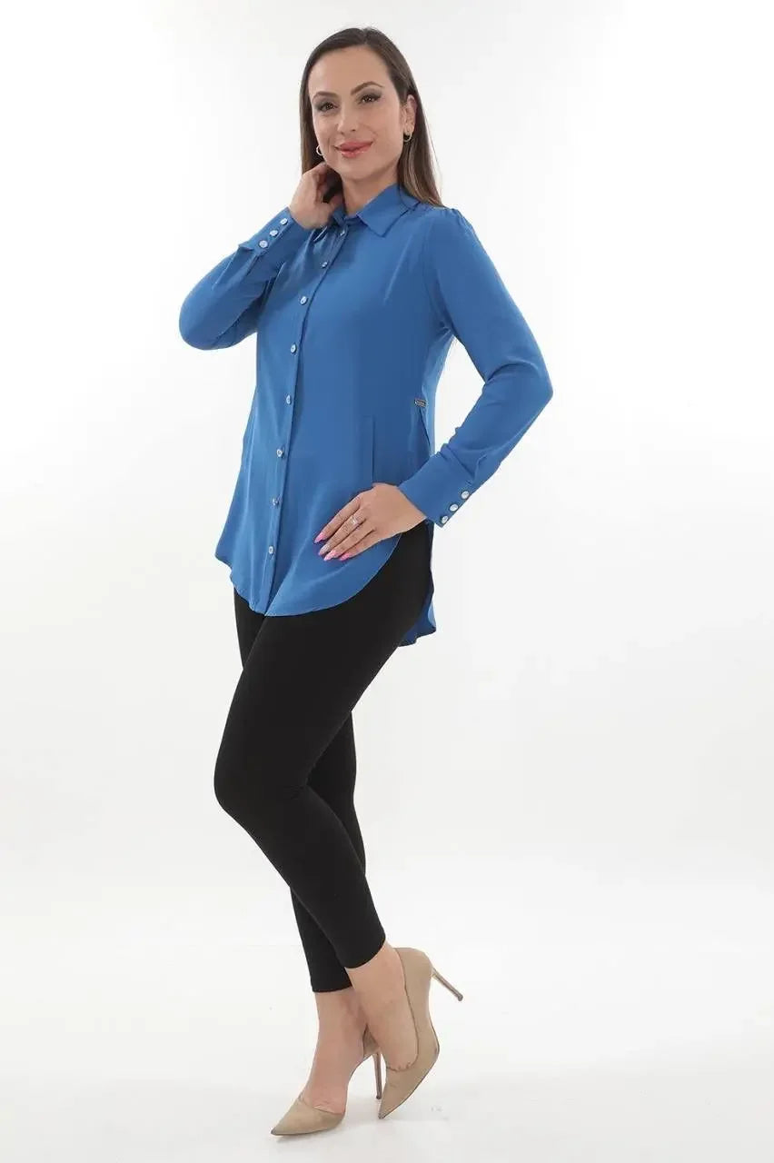 Blue casual embroidered blouse for women by Palestinian Elegance styled with black leggings and beige heels