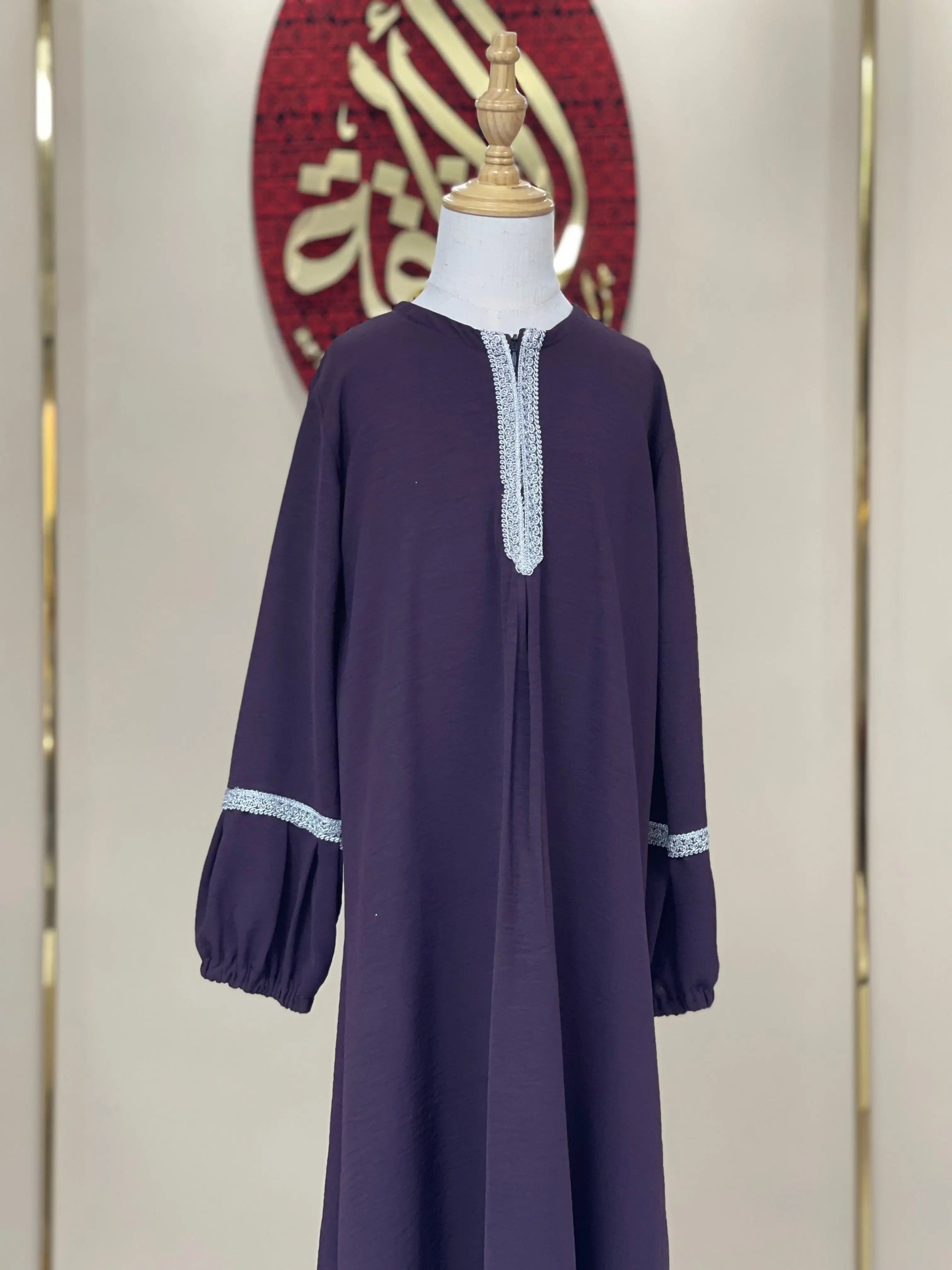 Palestinian Elegance girls embroidered abaya in deep purple with white embroidered detailing on sleeves and neckline