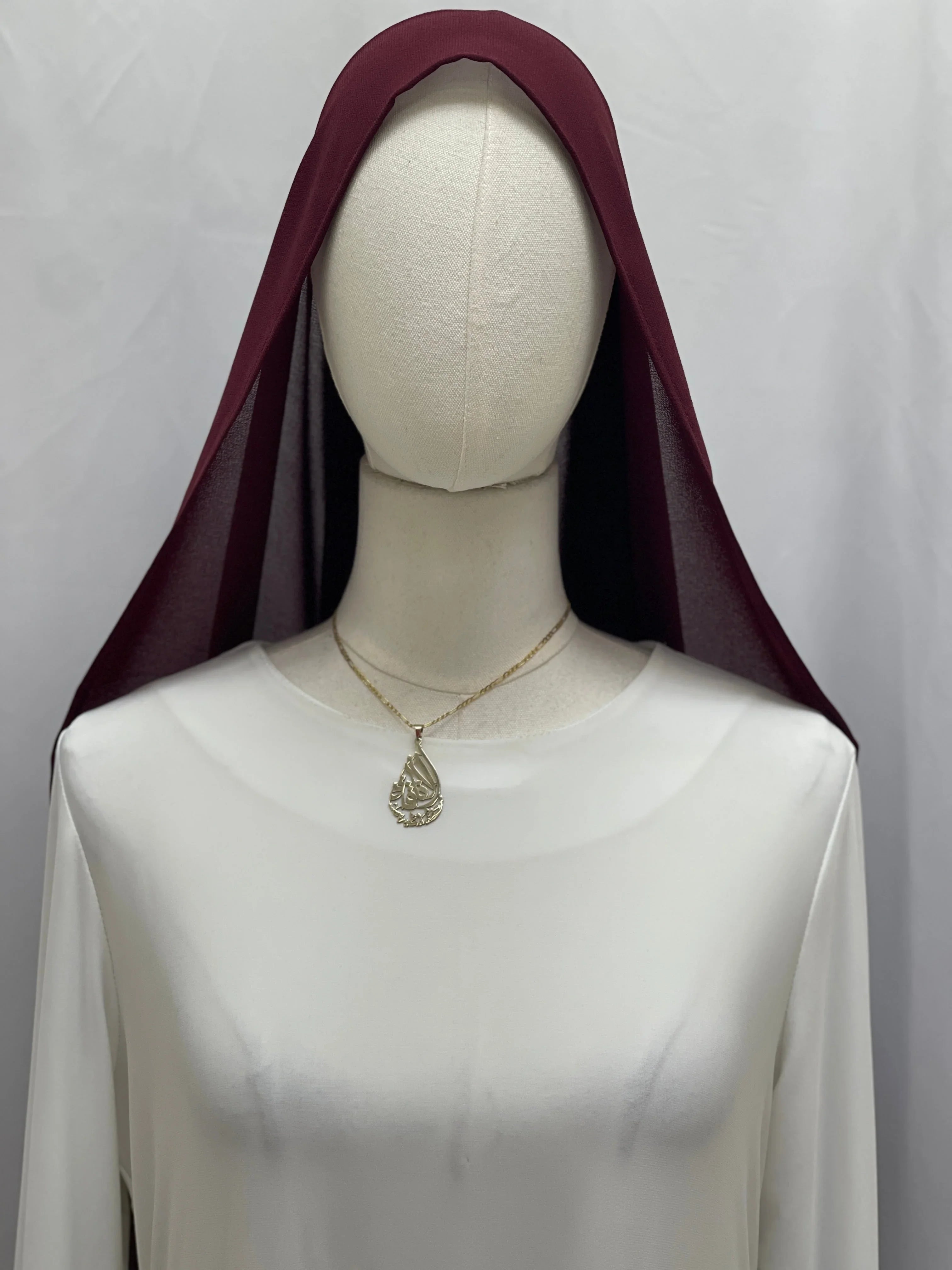 Dark Maroon Khirka With Tassel draped over mannequin head on white dress showing lightweight sheer fabric and gold necklace