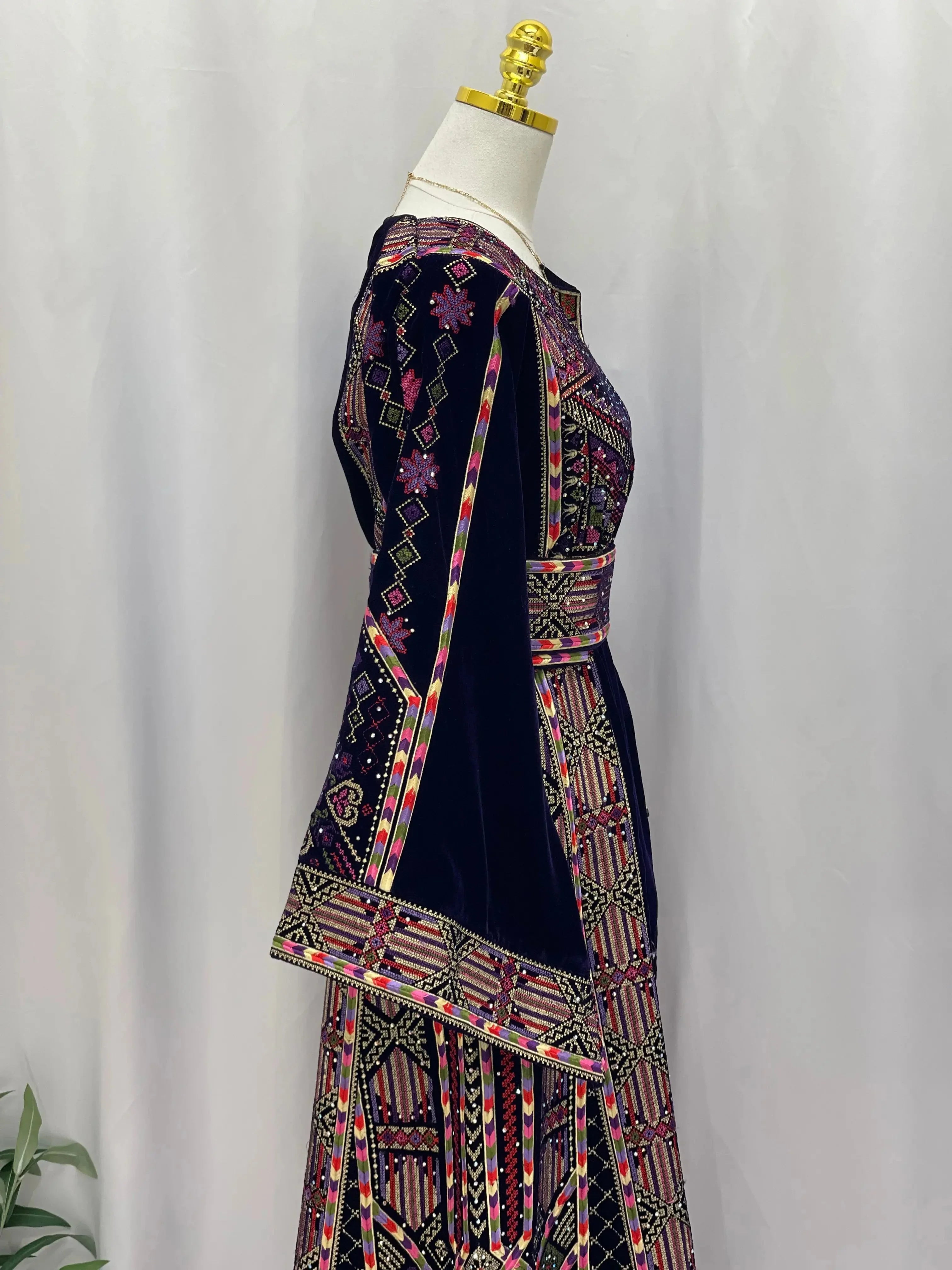 Palestinian Elegance embroidered velvet thoub with intricate colorful traditional embroidery on dark blue velvet fabric