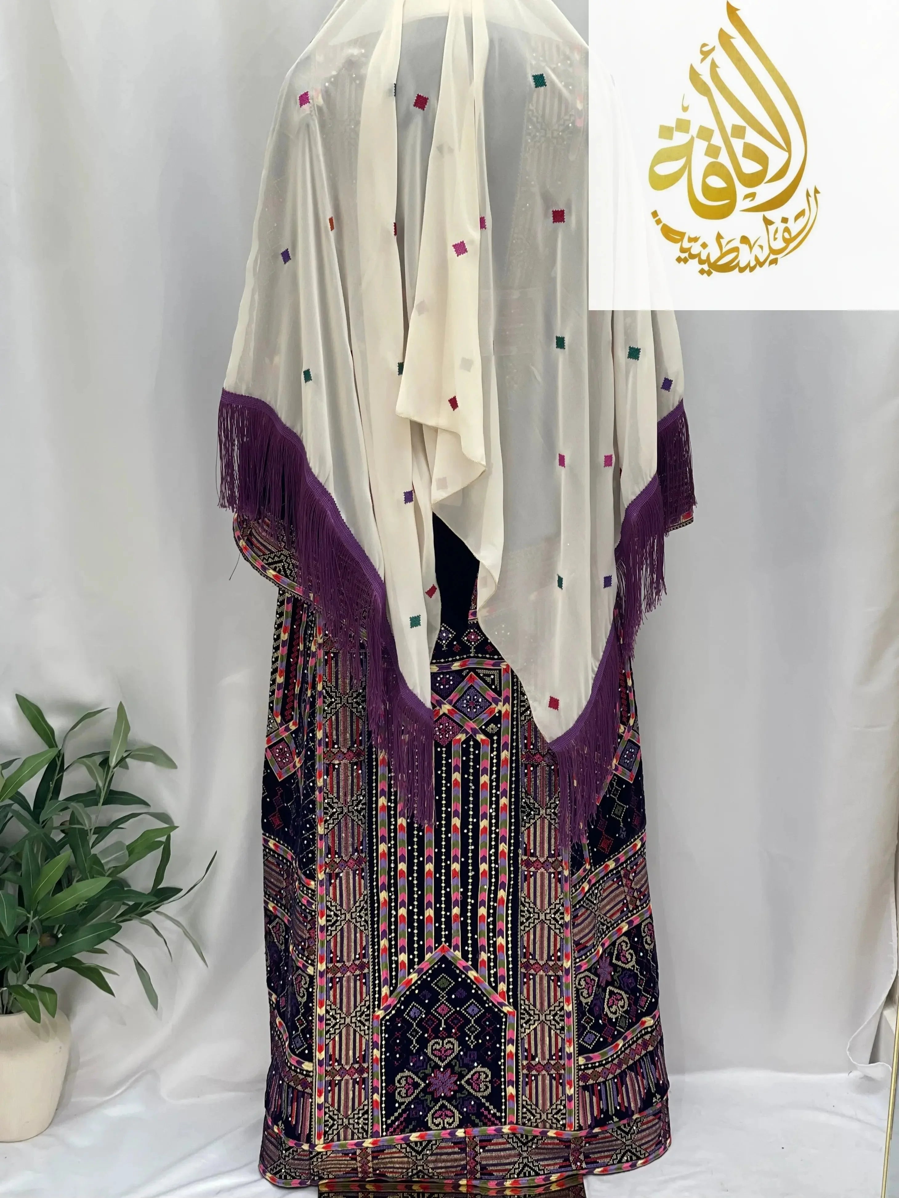 Palestinian Elegance embroidered velvet thoub with intricate colorful embroidery and cream shawl with purple fringe