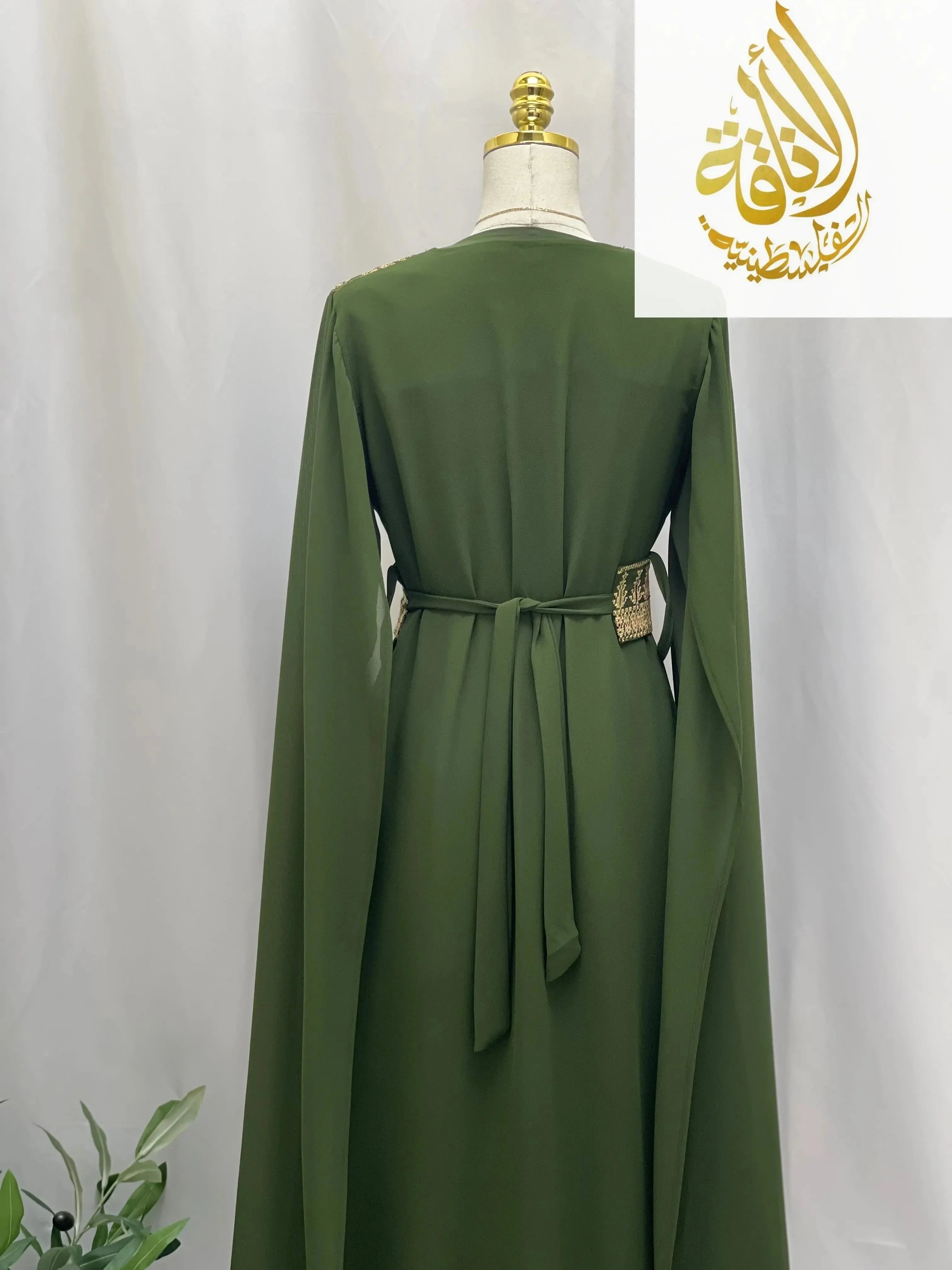 Back view of a green embroidered Palestinian dress with long sleeves and waist tie from Palestinian Elegance