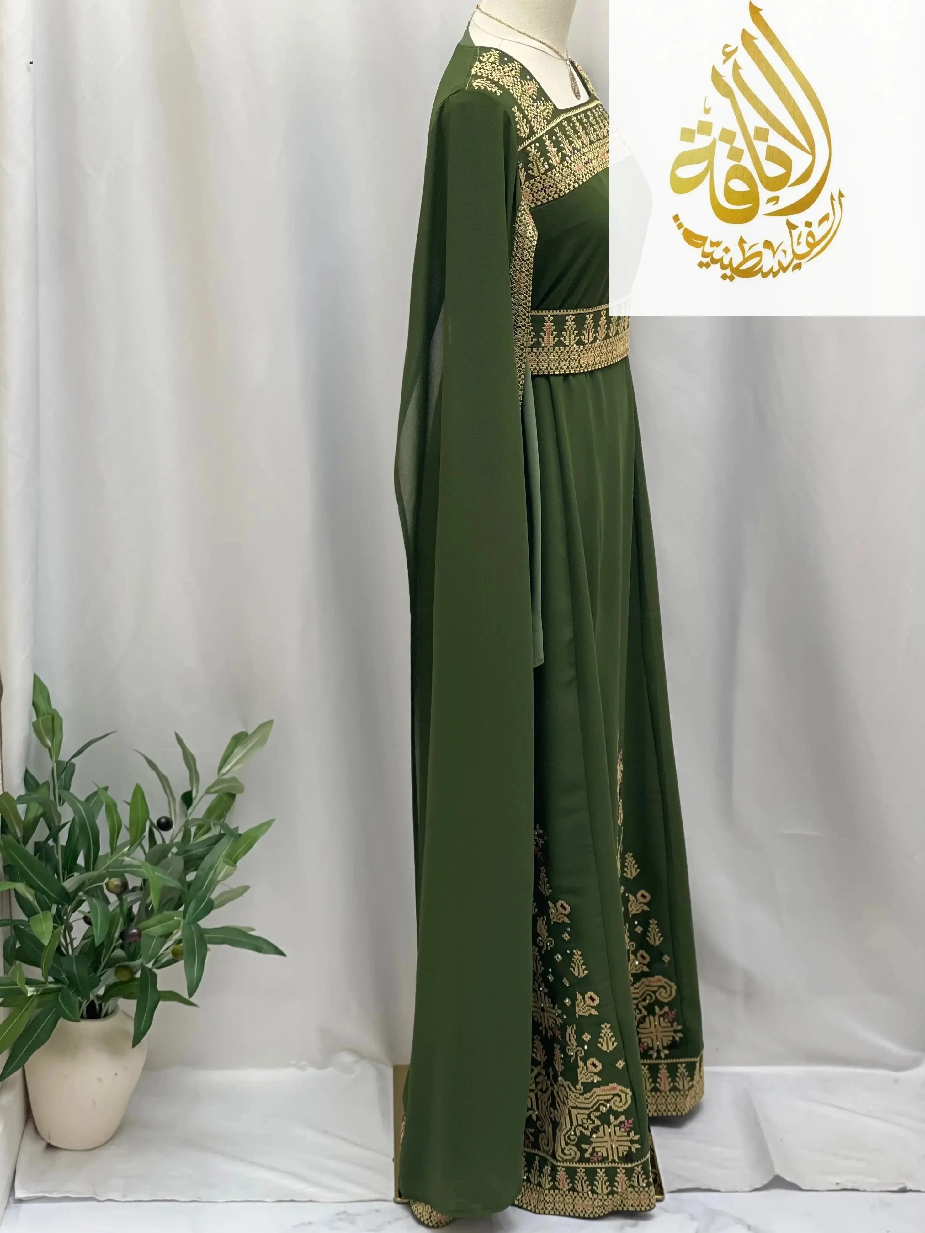 Green embroidered Palestinian dress by Palestinian Elegance with intricate gold embroidery details