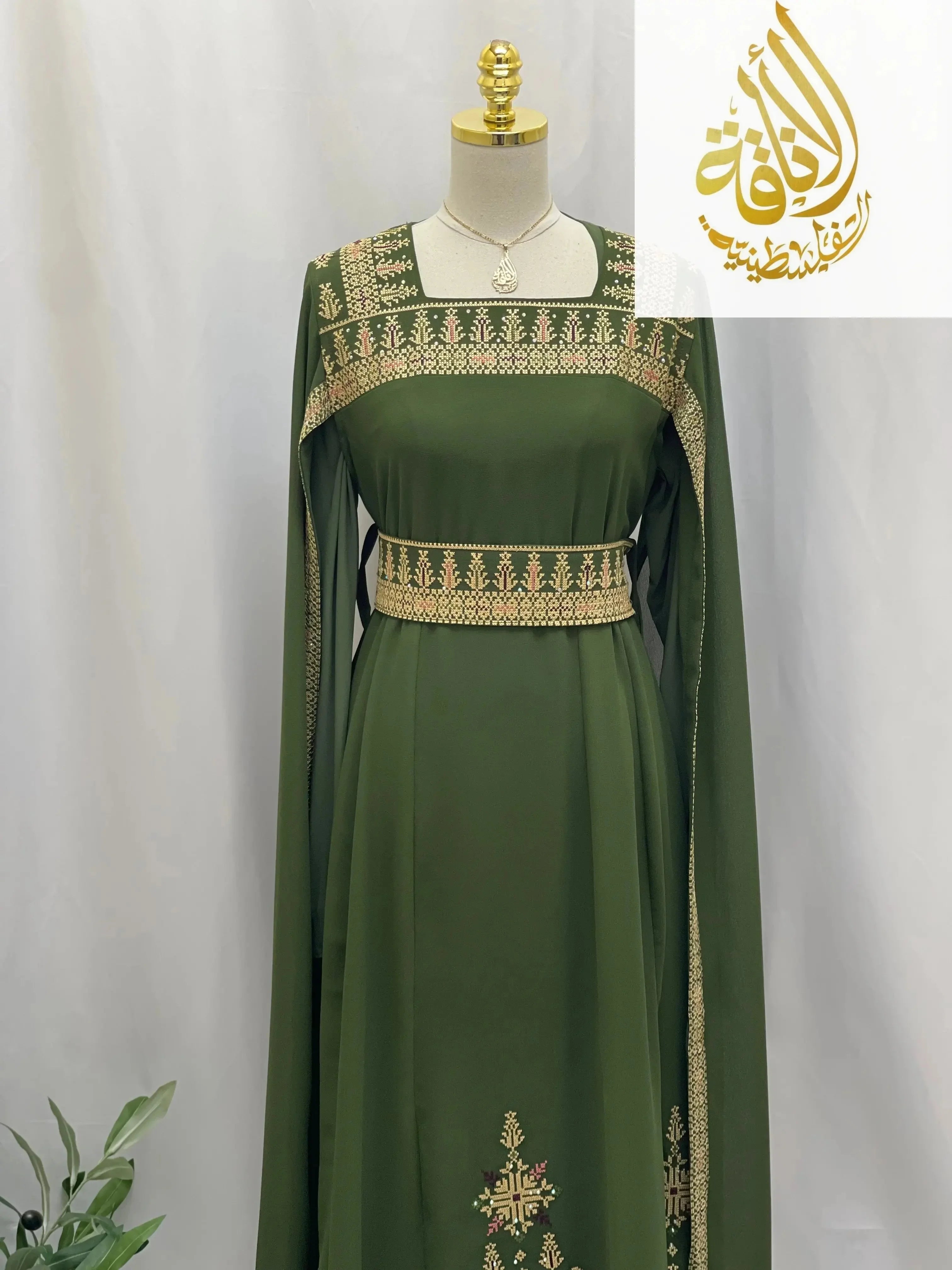 Green embroidered Palestinian dress with intricate gold detailing on chest, waist, sleeves, and skirt by Palestinian Elegance