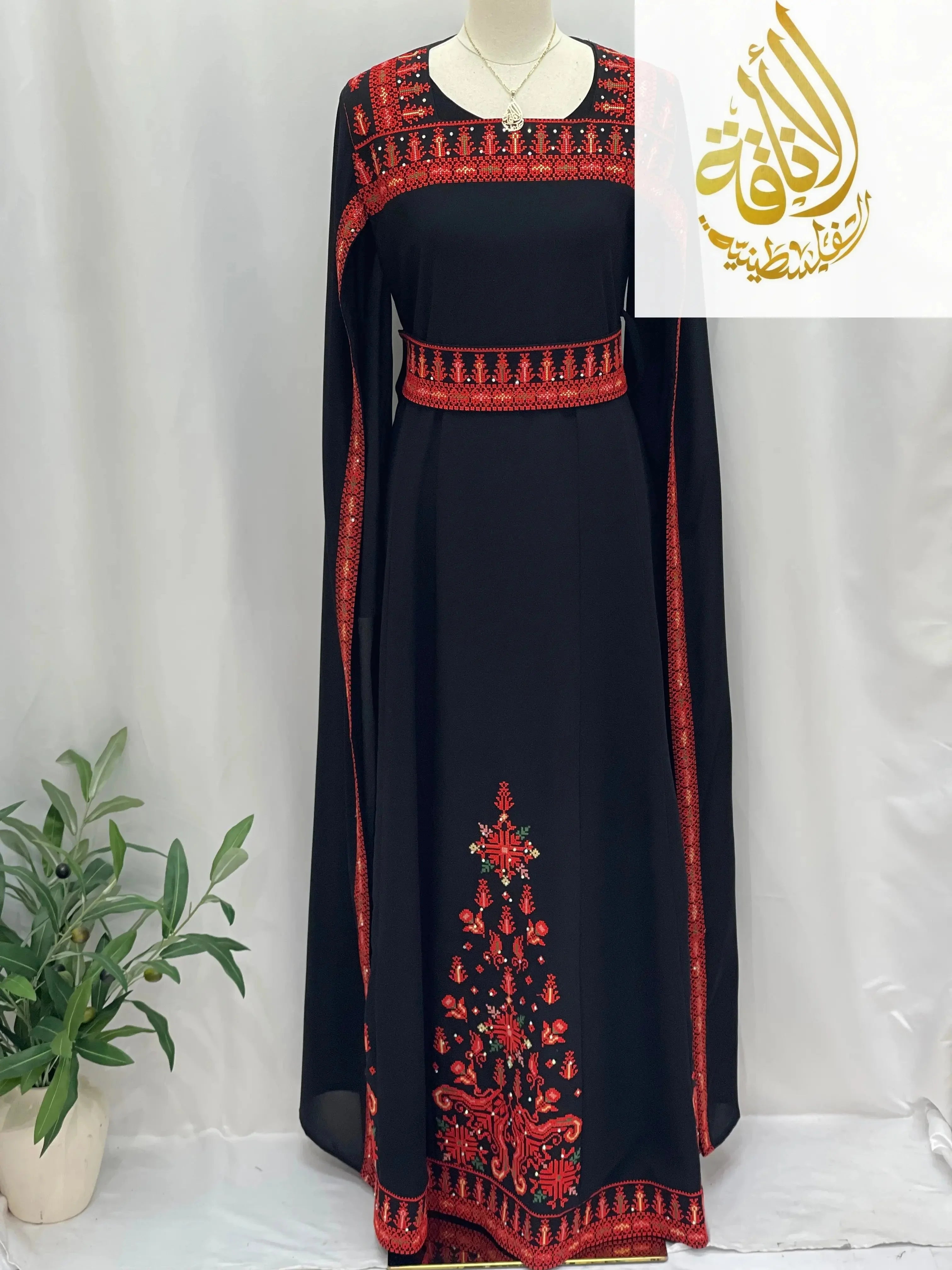 Black embroidered Palestinian dress with red traditional embroidery on neckline, sleeves, waist, and hem by Palestinian Elegance