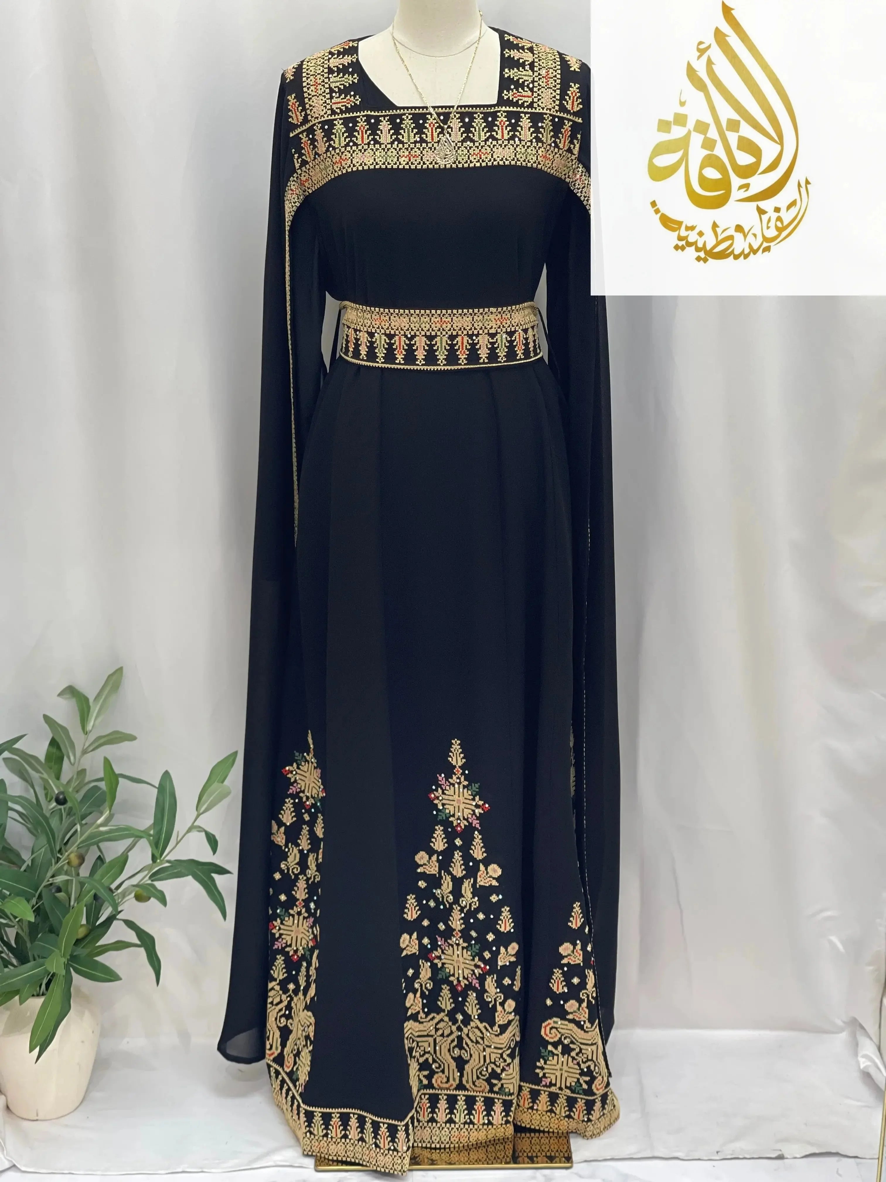 Black embroidered Palestinian dress with intricate gold and red embroidery from Palestinian Elegance