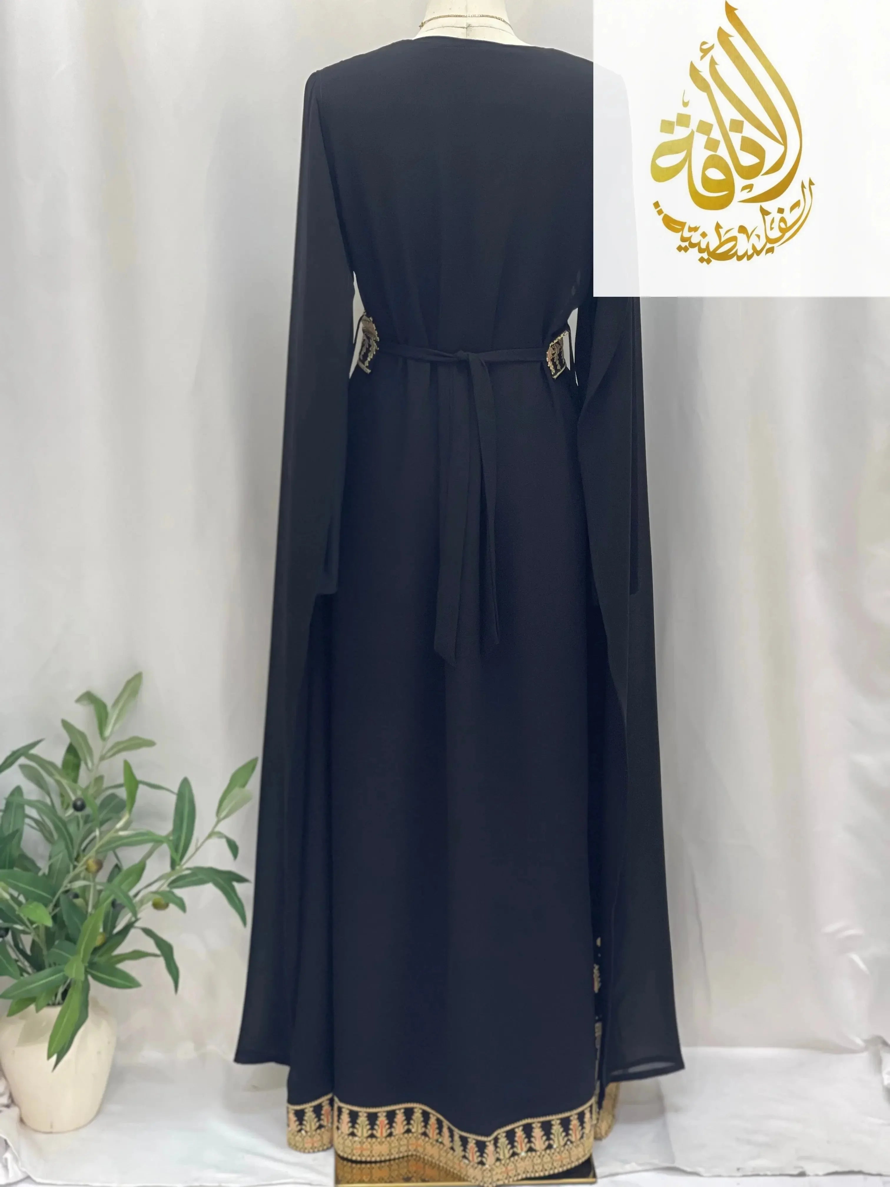 Back view of embroidered Palestinian dress in black with gold detailed embroidery and long sleeves