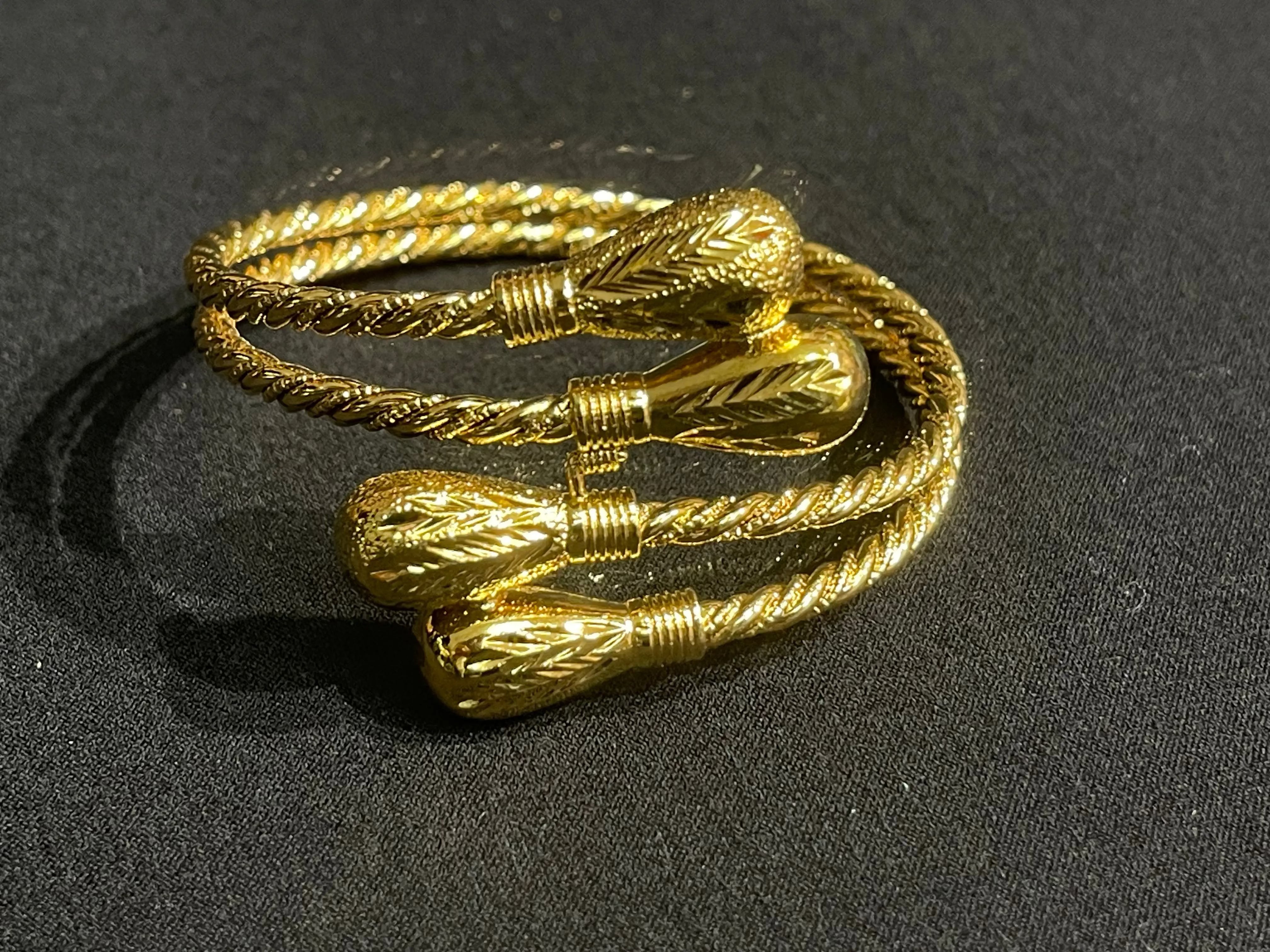 Palestinian Elegance imitated gold Palestinian gold bangle bracelet with intricate twisted design on black background