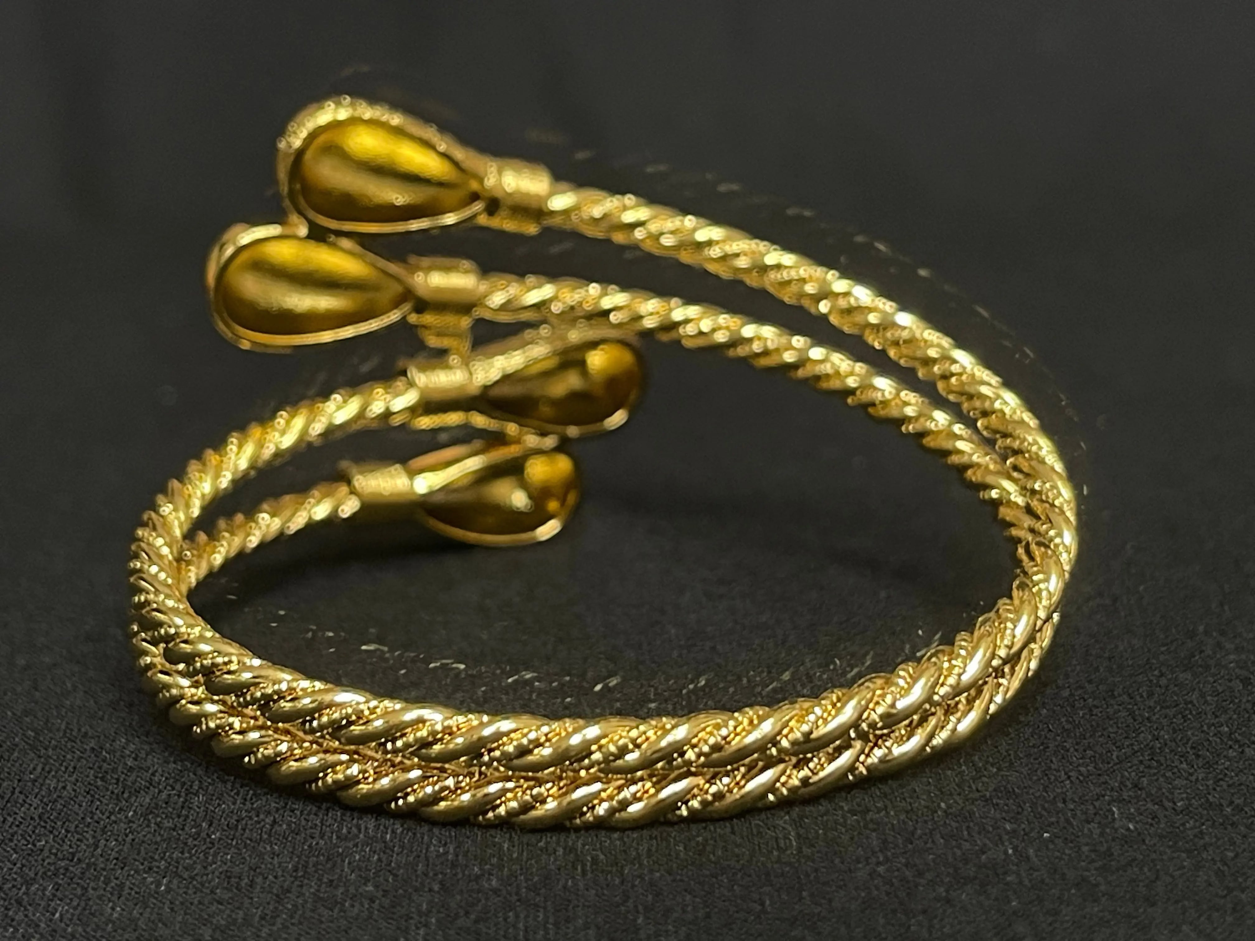 Palestinian gold bangle bracelet in imitated gold with twisted rope design and teardrop ends