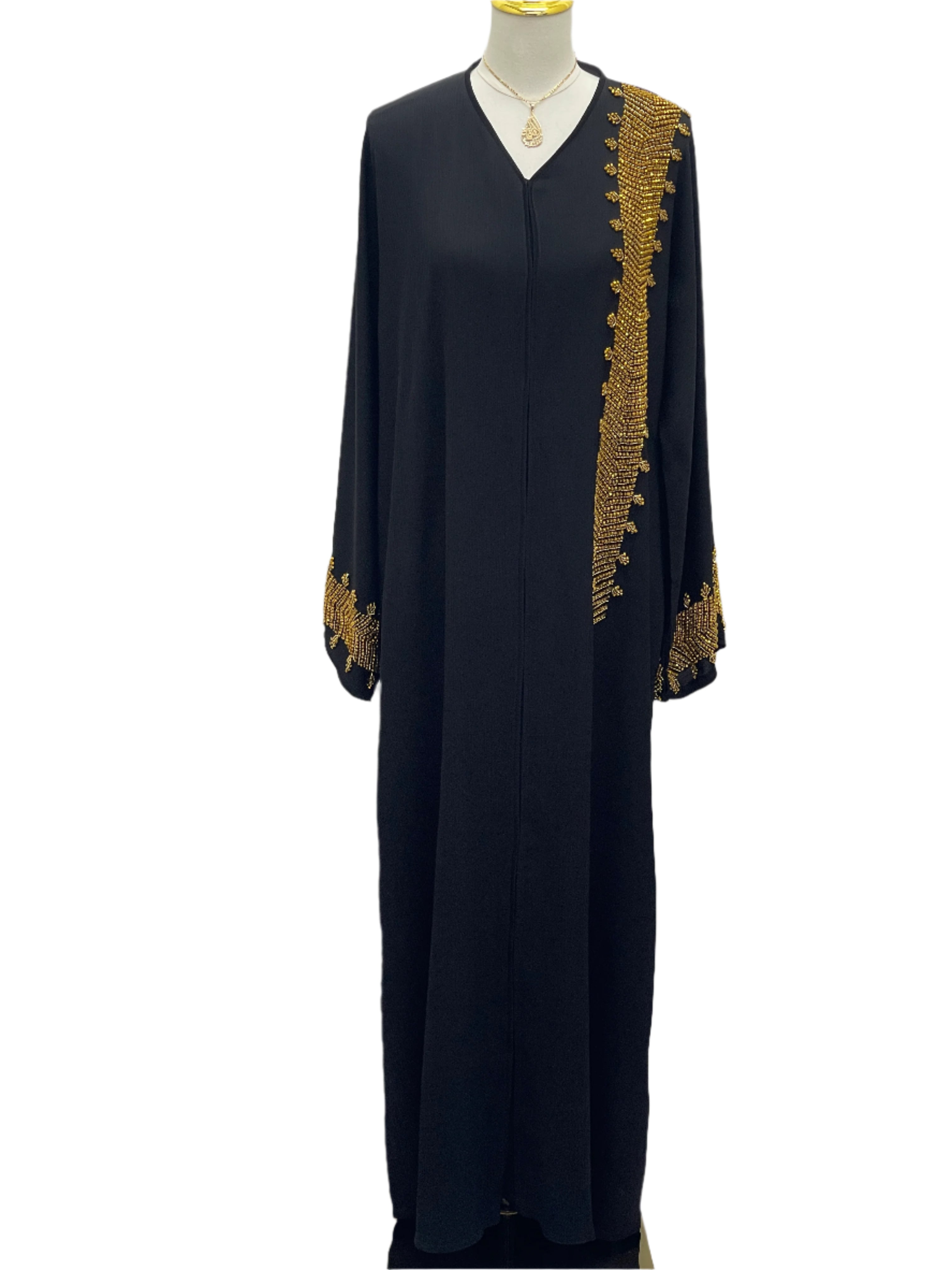 Palestinian Luxury Modest Fashion Abaya in black with intricate gold embroidery on sleeve and chest