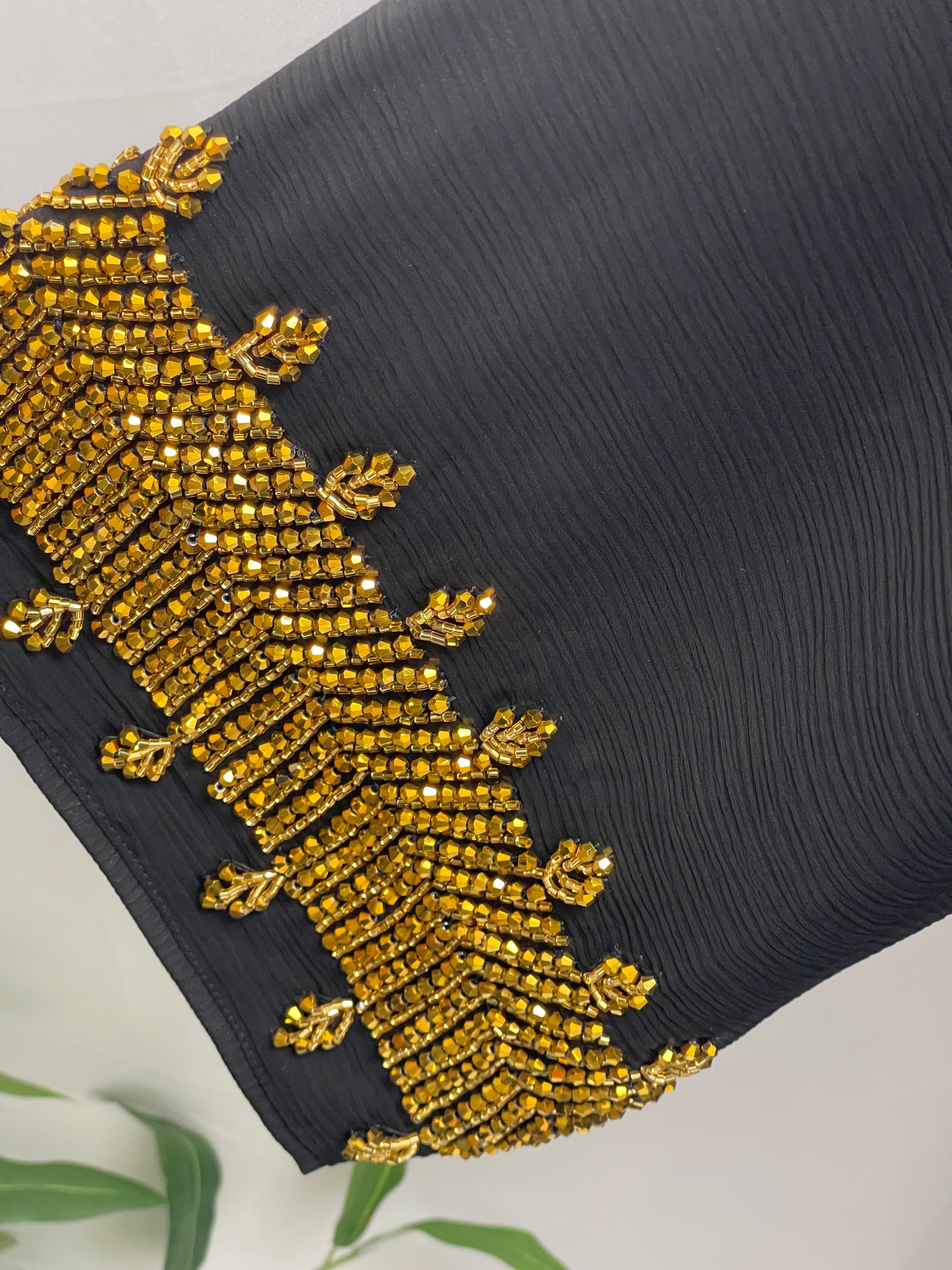 Close-up of black Palestinian Luxury Modest Fashion Abaya with intricate golden bead embroidery detail