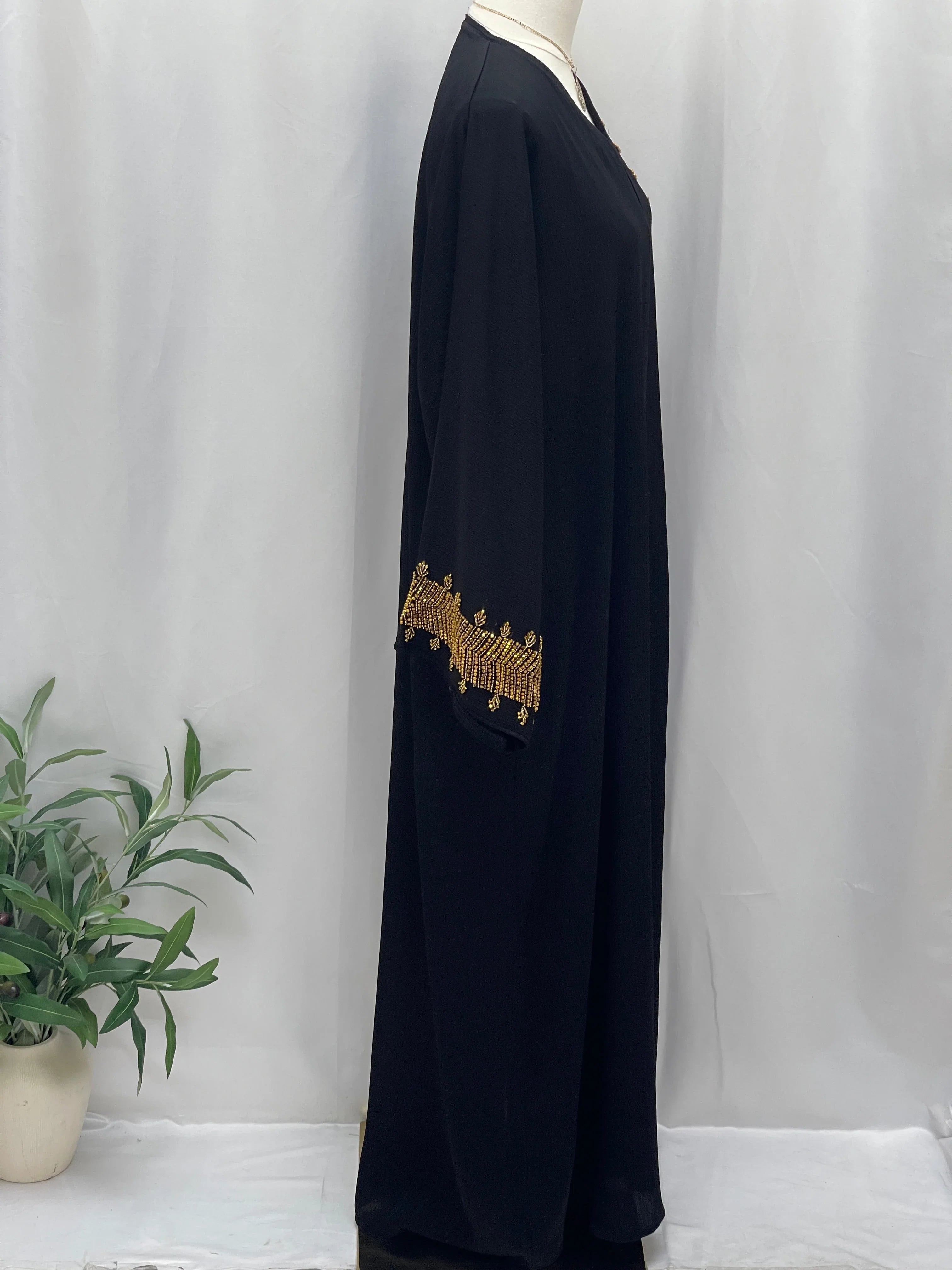 Palestinian Luxury Modest Fashion Abaya in black with gold embroidery on sleeves by Palestinian Elegance