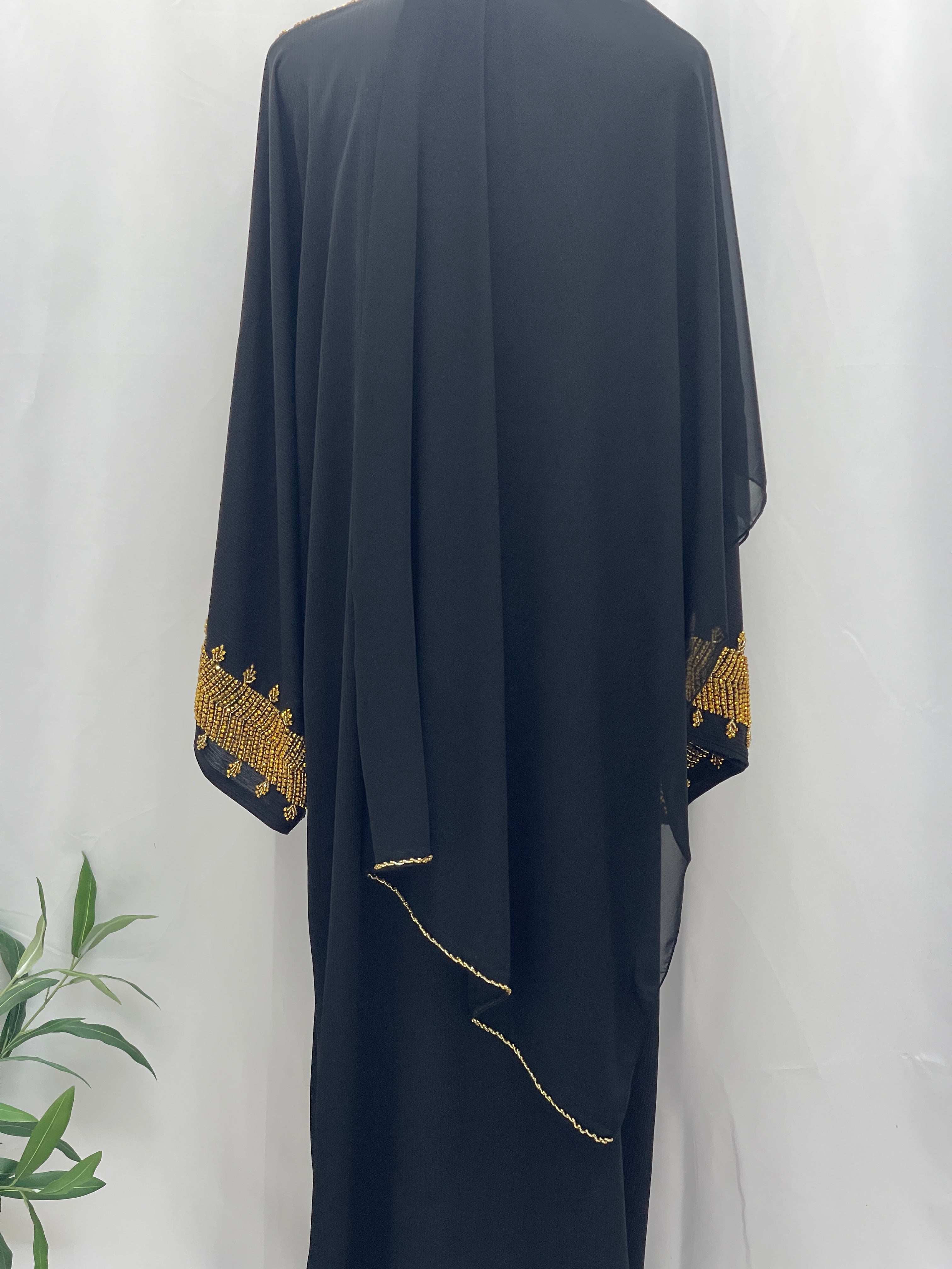 Black Palestinian Luxury Modest Fashion Abaya with gold embroidery on sleeves by Palestinian Elegance