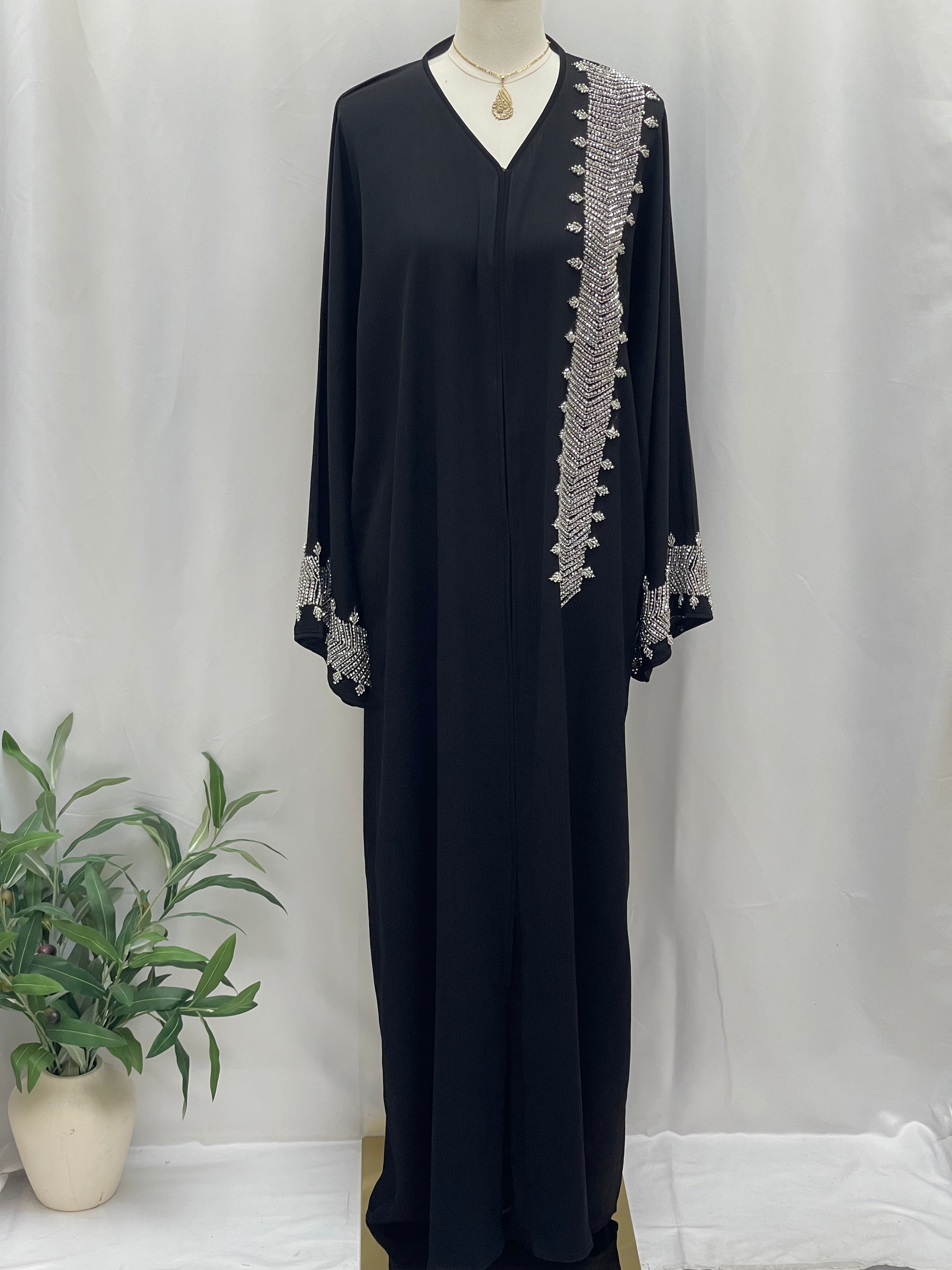Palestinian Luxury Modest Fashion Abaya in black with silver embroidery on shoulder and cuffs by Palestinian Elegance