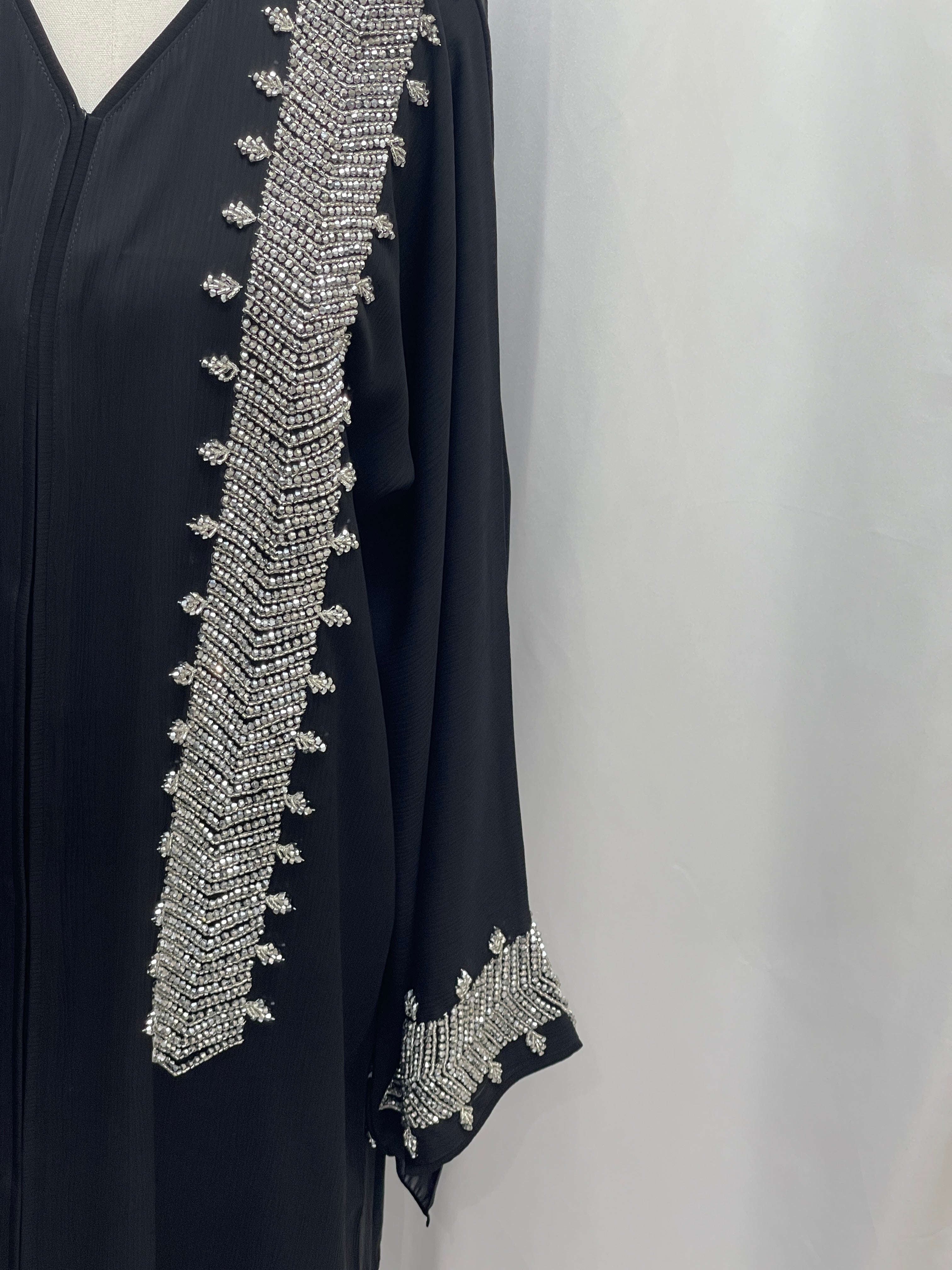 Palestinian Luxury Modest Fashion Abaya in black with intricate silver bead embellishments on sleeve and front