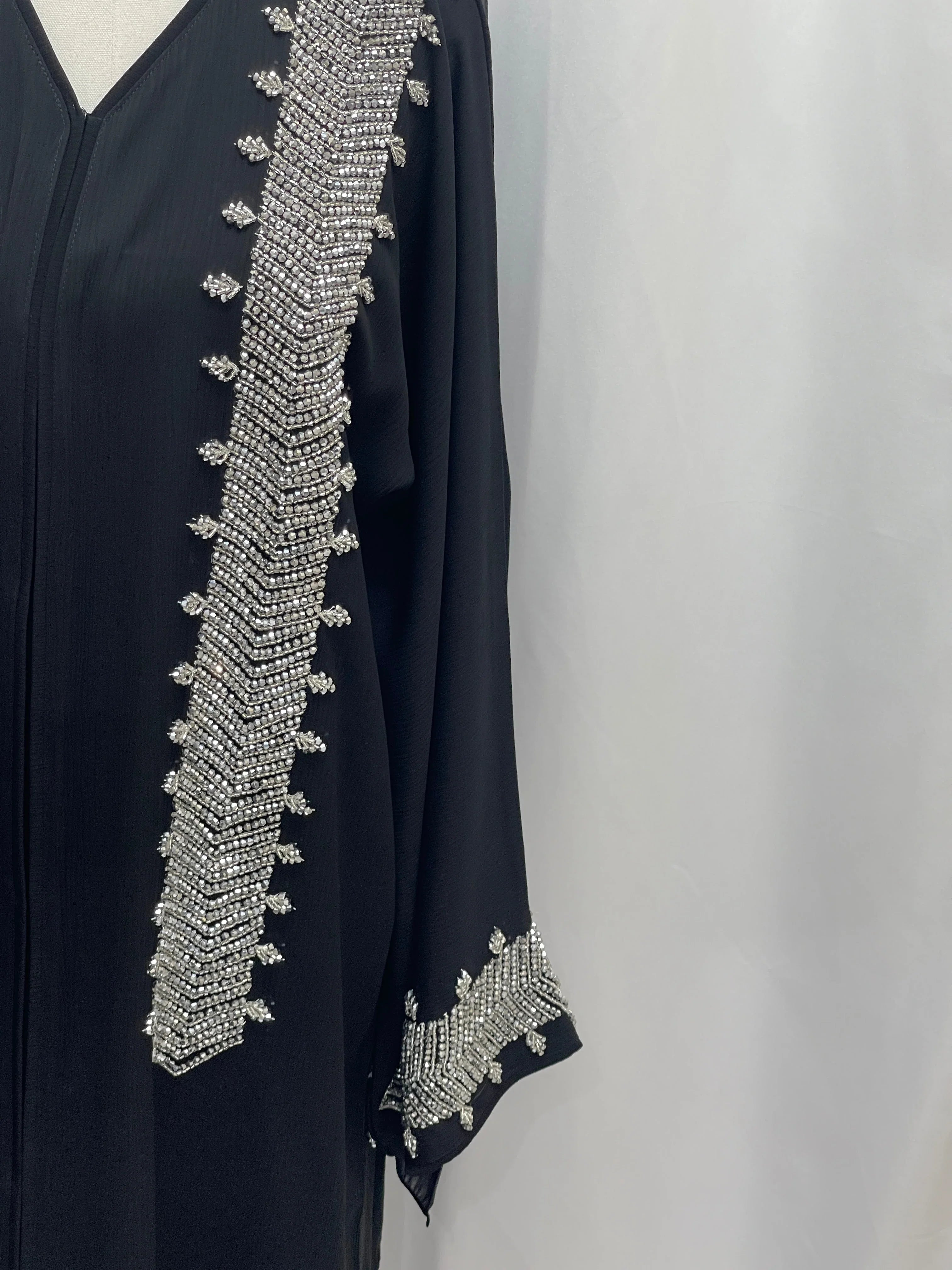 Palestinian Luxury Modest Fashion Abaya in black with intricate silver bead embellishments on sleeve and front
