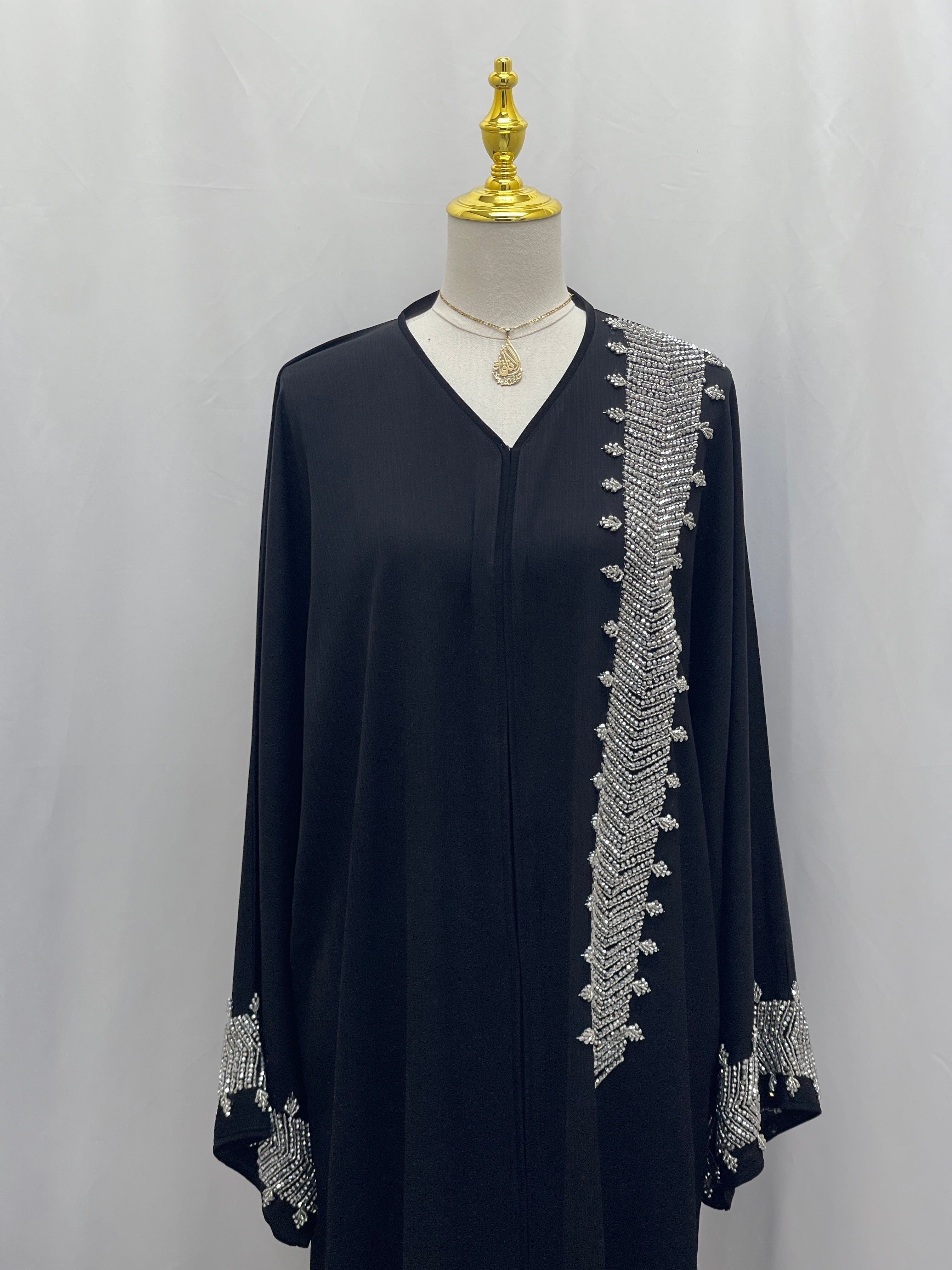 Palestinian Luxury Modest Fashion Abaya in black with intricate silver embroidery on front and sleeves