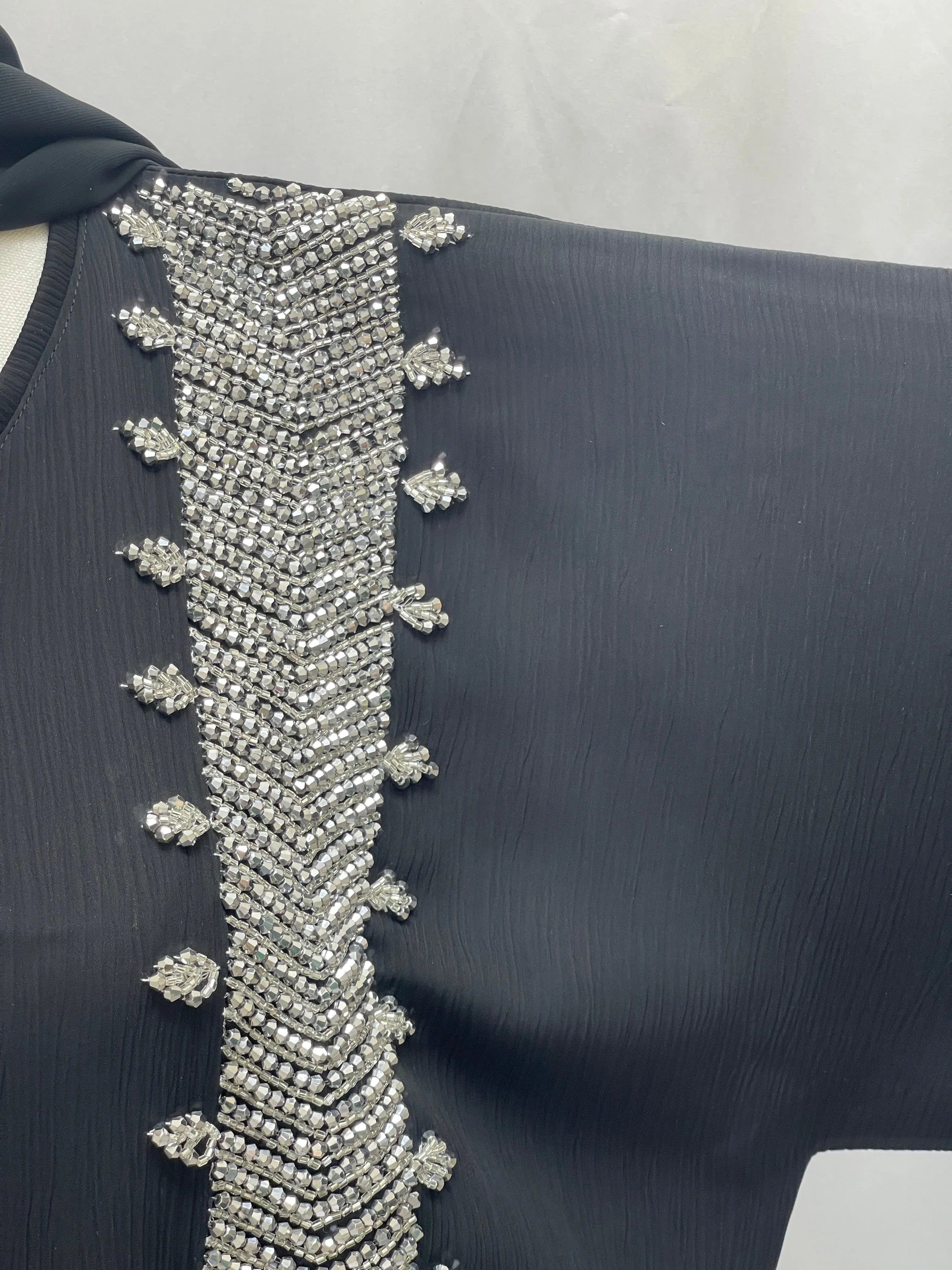 Black Palestinian Luxury Modest Fashion Abaya with intricate silver bead embroidery detail on the sleeve